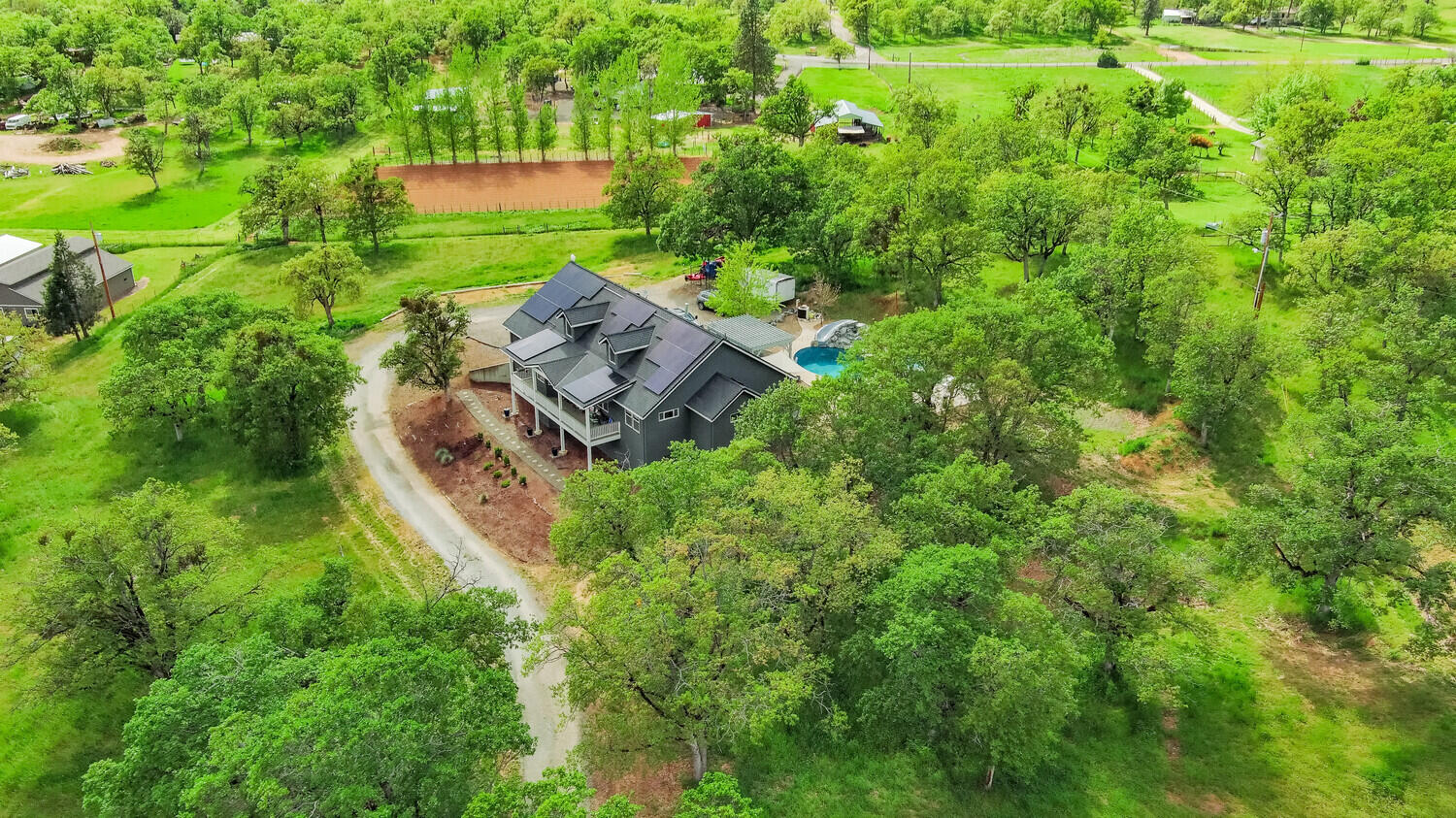 Welcome to your own private oasis! This stunning home boasts 4 bedrooms & 3 baths w/over 3,100 sqft on 4.7 fenced & gated acres w/pasture land perfect for horses. Fabulous Mother-in-law suite over garage provides extra privacy for guests! Enjoy gorgeous sunset views from the main home, tall ceilings, lg windows, skylights & abundant natural light that creates a warm feel. The finished basement is a wonderful bonus area w/a gym, dry bar w/wine fridge & secret storage rm! The primary suite is a true retreat, w/fully remodeled bath (2021), huge dreamy closet & private entrance to hot tub for easy access for relaxation. Backyard will provide hours of fun & memories w/a brand new custom lagoon-style saltwater heated pool w/a slide & waterfall. Gazebo is plumbed & ready for an outdoor kitchen that would be perfect for hosting family & friends! High-producing well last tested at 28 gal/min. Solar system offers energy efficiency & savings! Starlink Internet included with the home!