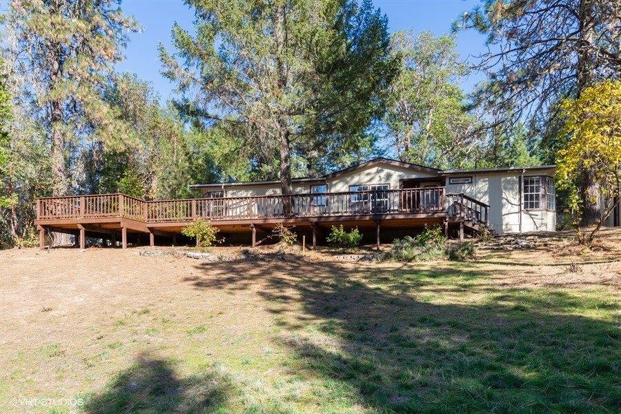 Nice 3 bedroom 2 bath doublewide on over 3 acres with a detached 2 car garage with an additional workshop area and a covered storage area. This property features a new large deck, new paint inside and out, new carpet, two eating areas, a large living room and a nice kitchen.