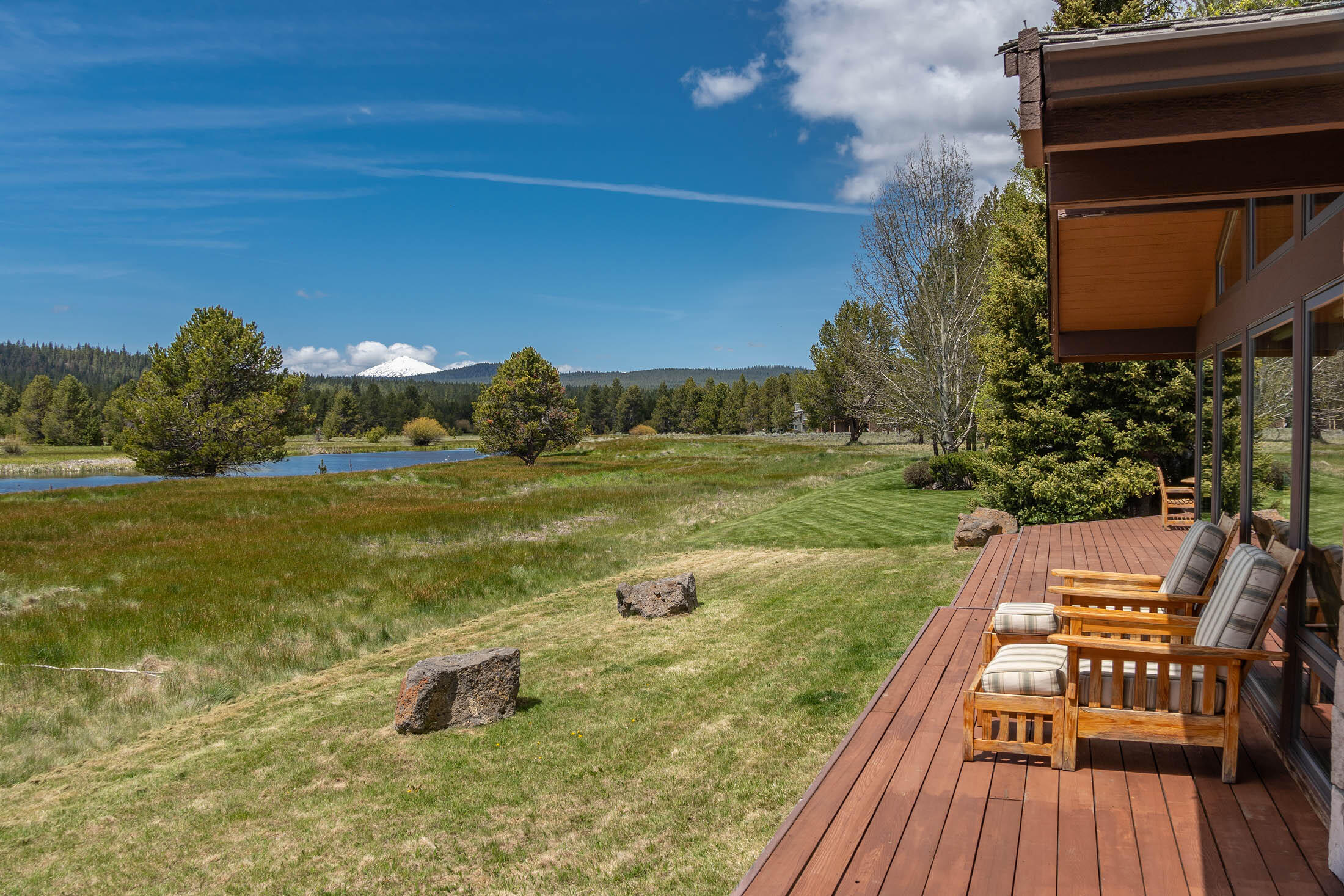 If you dream of mountain views, golden sunsets or star filled night skies as you enjoy your perfect Sunriver escape, you will find it in this home. With this 4 bedroom 3 bathroom home you can make it the perfect get away for the whole family. This home greets you with beautiful stone and pine floors, perfectly inviting the outside in, and invoking inner peace and tranquility from the moment you arrive at this river front home. Upon entering you'll find yourself drawn to the living room to take in the views of Bachelor, Sun River, forest and all the breath-taking beauty. Following the floor-to-ceiling windows you'll wander into the kitchen where you'll be greeted by a classic Chef's kitchen and an island that expands over half the room.  Make this home the perfect getaway for you and your family!  Features include: heated floors in the bathrooms, work out room off the garage, Viking double ovens, range, Viking refrigerator, Bosch dishwasher, 2 heat pumps, 2 furnaces.