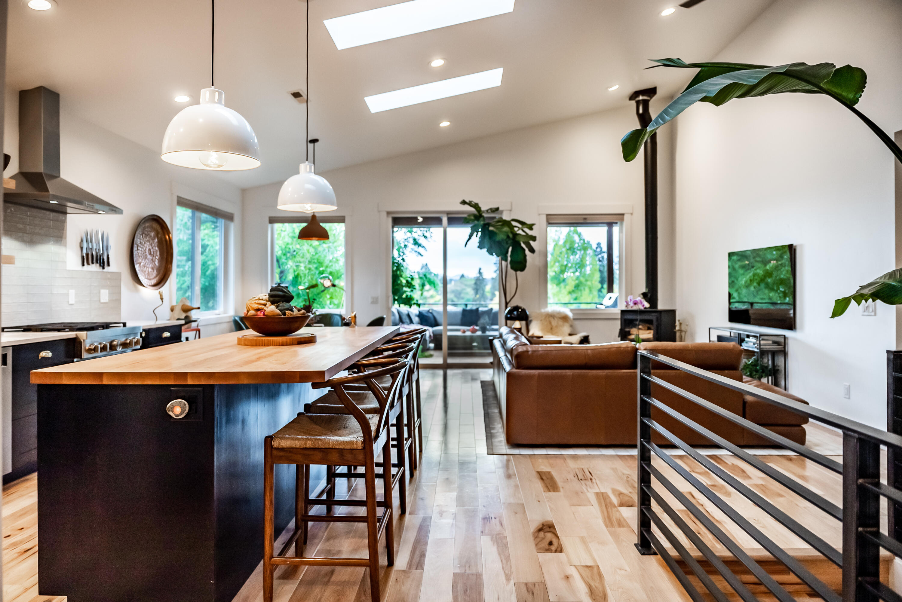 Open Sat. 11/5, from 1-3pm. Newly constructed in 2020; this dwntwn, 2-lvl, 3 bdrm + office, 3.5 bath, custom treehouse-style home, set on a serene, dead-end st., enjoys both the sounds of the Deschutes River & dynamic green outlooks from every window. Flooded w/ perfect natural light & refined by a designers touch, the soaring ceilings of its dramatic lvng space gives way to an artfully designed covered deck that functions as a 2nd lvng room - views S. include Tower Theater, Old Mill Smokestacks & Newberry Monument. The homes reverse lvng floor plan offers huge flexibility. For a single lvl option, enter the home via the alley w/ a 2 car SxS grg + strg. You'll find the primary ste, w/ spacious closet & deep soaking tub, an incredible kitchen that is highlighted by a massive island; natural & striking, large laundry room, 1/2 bath & pantry + a living/dining space w/ a wd brn stove opening to the most fabulous deck that spans the front of the entire home. Scroll photos for more detail
