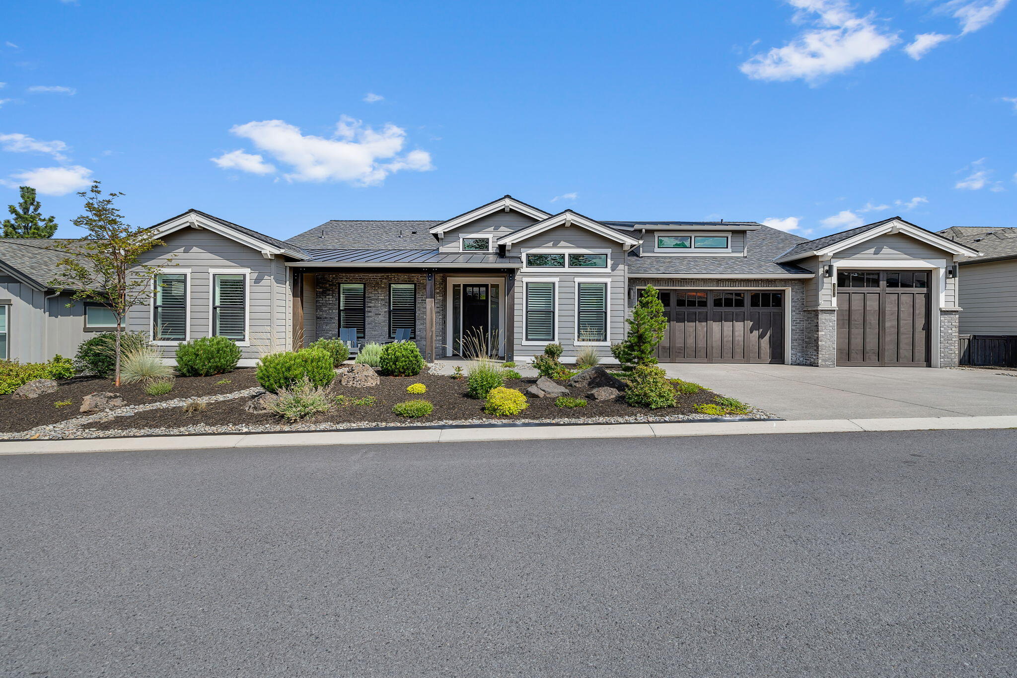 This award-winning Brennan plan by Pahlisch Homes in River's Edge offers 3,373 sq ft of single-level living with 4 bedrooms, a flex room, and a den. The open-concept design highlights 10 ft ceilings with beams in the main living area and a chef's kitchen with premium Jenn Air appliances. A large heated covered patio showcases stunning views of the Ochocos and Pilot Butte, ideal for year-round enjoyment. The luxurious primary suite features dual vanities, soaking tub, tiled shower, and walk-in closet, while secondary bedrooms provide comfort and privacy. Ample storage is found throughout, including a 3-car garage with epoxy finish, plus a third bay featuring a 10 ft door for larger vehicles or gear. Located in the River's Edge community, residents enjoy trails, open spaces, and proximity to the Deschutes River, golf, and vibrant downtown Bend.
