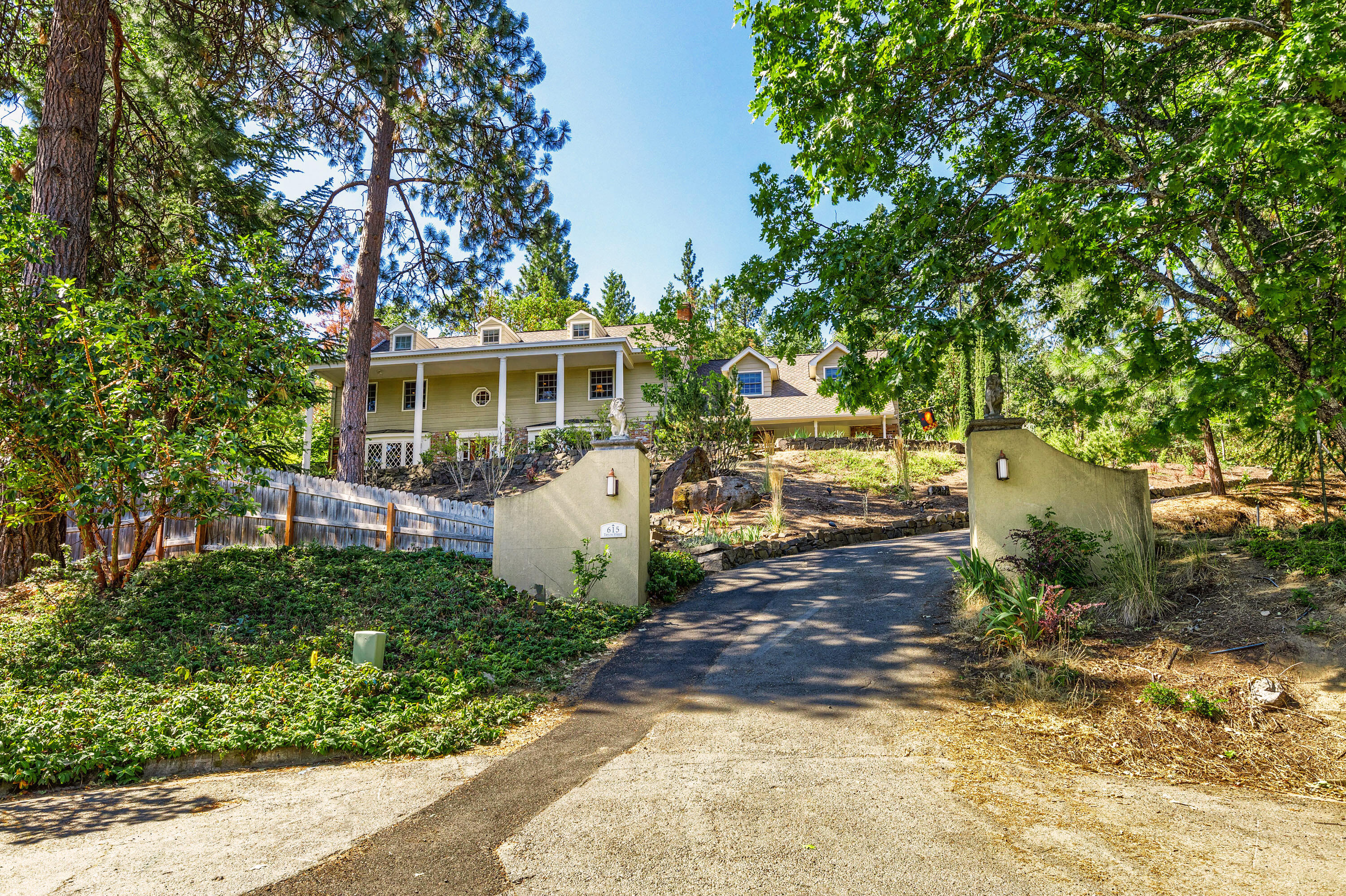 Premier Ashland Property, nestled in the hills of Southern Oregon, minutes from Southern Oregon University, 5340 Sq Ft, executive home on .99 acres with stunning views of Grizzly Peak,1 mile from downtown. Gated drive with two entrances. The home  boasts 3 stories & 4 fireplaces, plumbed for gas. Main floors feature Brazilian Cherry Flooring, spacious dining and living rooms, a luxurious master suite with attached office, limestone floors w/radiant heat, glass tile steam shower and soaking tub, 4 additional bedrooms, 3.5 baths. Potential for 2 family set-up. Library, commercial grade bar, chef's kitchen with 6 burner stove, double ovens, subzero frig and wired for sound throughout the home. Enjoy the inground pool/ hot tub, meticulous landscaping and renovated outdoor spaces. 30 foot waterfall, 1/2 basketball court, a 3 car garage and access to miles of hiking /biking trails from the property. Plenty of extra parking for RV, boat and toys.