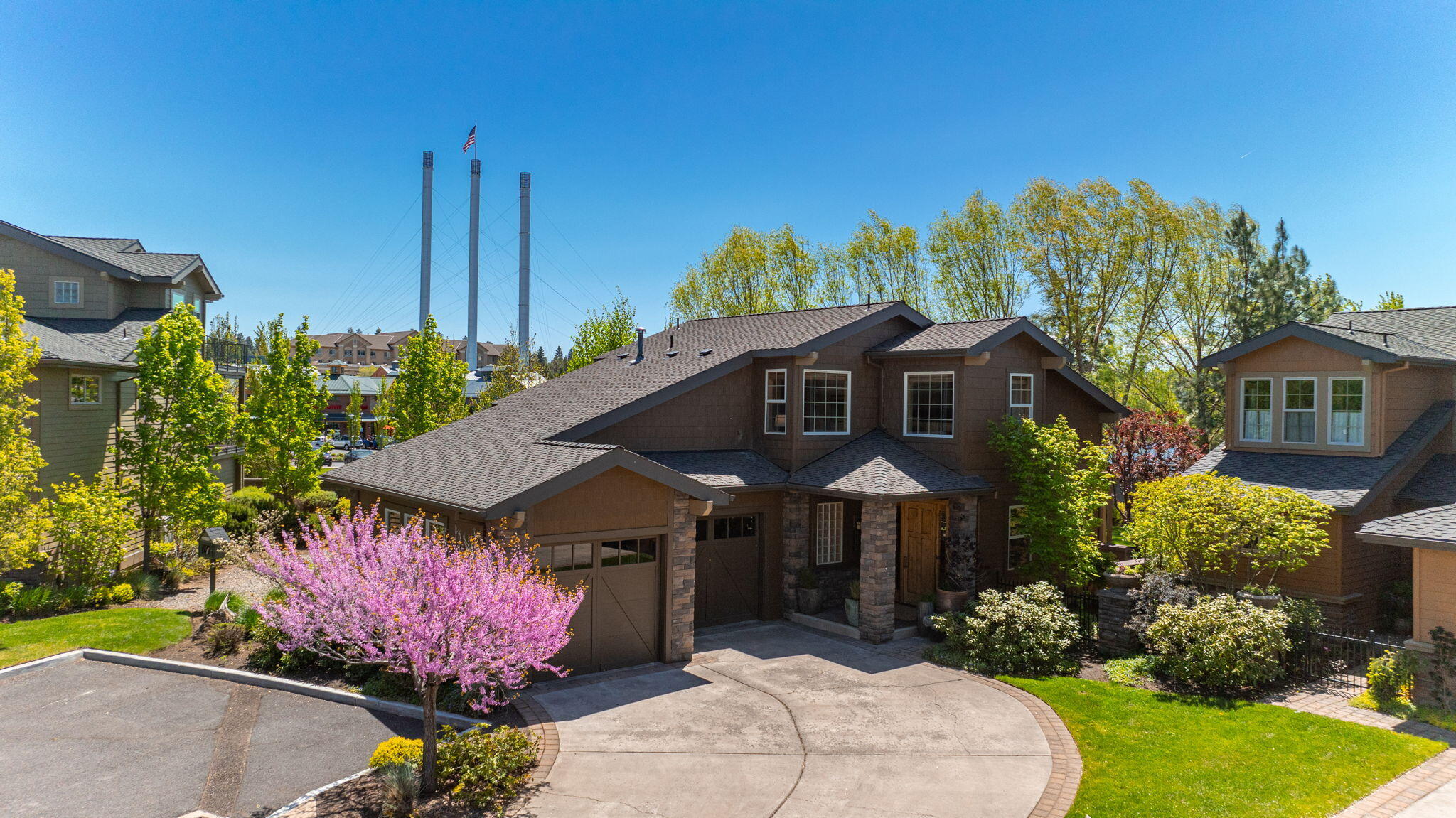 Experience the Bend lifestyle from this coveted RIVERFRONT property steps to the Old Mill & moments to Downtown. Situated on a private .14/ac fenced lot w/stunning river & Cascade views, this home boasts exquisite NW Contemporary design throughout. Great Room features soaring ceilings, exposed beams, floor-to-ceiling steel fireplace, concrete flooring, & a wall of windows blending indoor/outdoor living seamlessly. Chef's Kitchen w/slab granite, SS appliance & wood slab working island. Main Level Primary Suite w/access out to back deck, offers a luxuriously remodeled bath w/separate vanities, soaking tub, tiled shower & radiant floors. 2nd level: Loft Bonus/flex space, 2 additional bedrooms (one w/fabulous views of the river & Cascades) + Jack & Jill bath. Multiple outdoor spaces IDEAL for entertaining & a prime spot for summer concerts from across the river. Walk out your back gate w/your paddleboard or running shoes and enjoy immediate river & trail access. Truly a RARE opportunity!