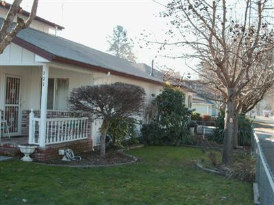 The large 1,647 sf home is loaded with storage space and extra hobby rooms (there's a 450 sf loft that would be a perfect artist's studio). 1,647sf home PLUS a 700sf 1bed/1bath apartment. The home and apartment EACH have a garage PLUS a 30' RV garage. Newer appliances (even washer & dryer) are included. There's an indoor hot tub and spa room next to the indoor greenhouse. Mature landscaping is maintained by timed underground sprinklers. Well maintained. Owner will carry.
