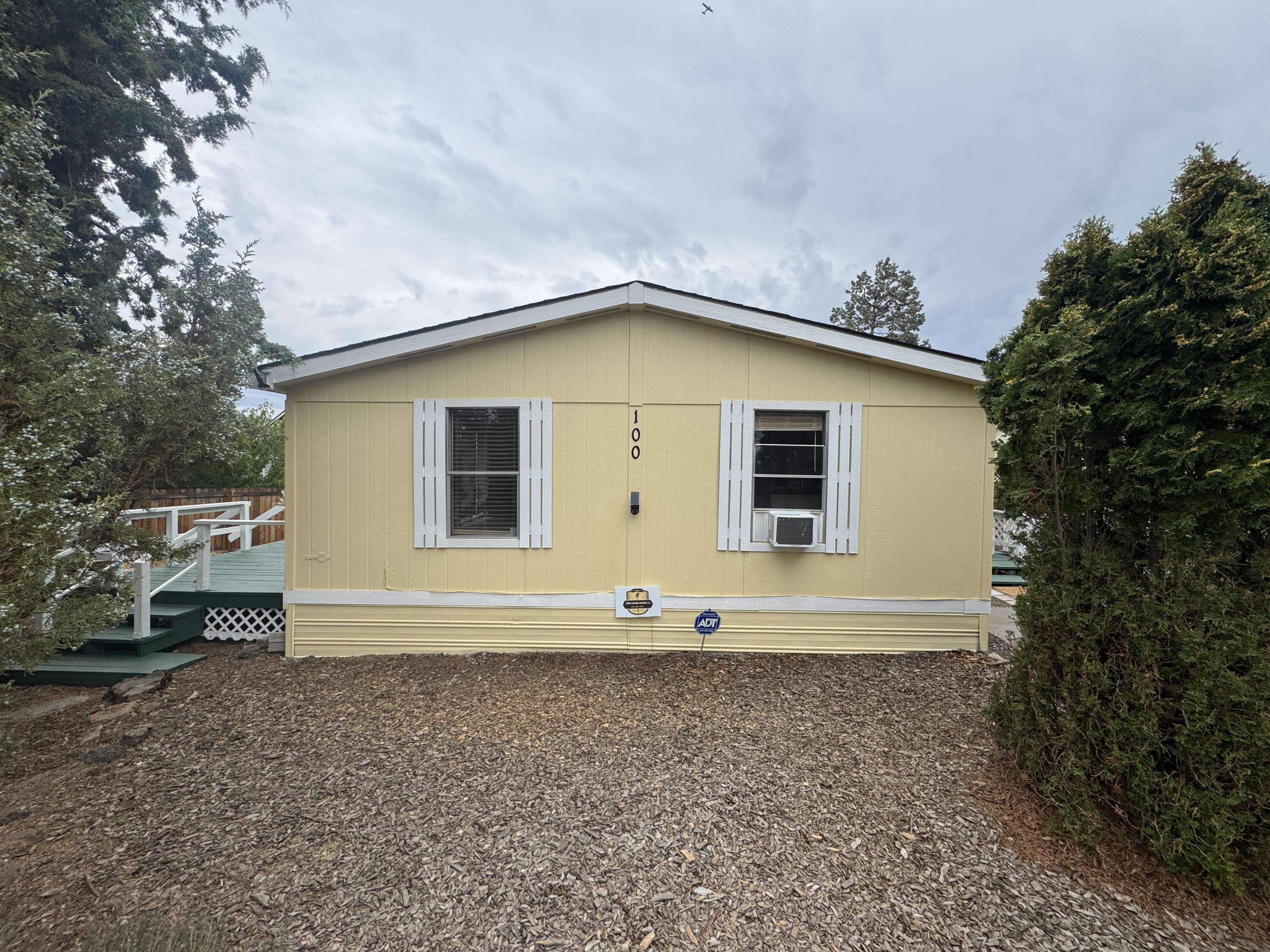 This beauty is privately located in the Green Pastures Senior Co-op Mobile Home Park, which is a serene community reserved for individuals aged 55 & older. This well-maintained home features vaulted ceilings, new carpet & luxury vinyl plank flooring throughout, new exterior paint, a large primary suite with walk-in closet & shower/tub combo, a nice covered front deck, a huge rear deck w/partial coverage that's great for entertaining, outdoor cooking & privacy, & 2 storage sheds are included for all your belongings,. The property includes a carport for sheltered parking along w/several other parking options being located at the end of the street, The community is located in a very desirable area close to all amenities & just blocks to Redmond's dry canyon trail system. Space rent of $385 offers a very affordable living option in this desirable community. Prospective buyers must undergo an approval process before finalizing the purchase, ensuring compliance w/ regulations & guidelines.