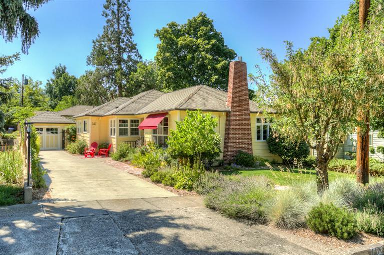 Fabulous 1945 home with separate cottage. You will love this immaculate property. Thoroughly remodeled main house with attention to detail so the period was restored and preserved where possible. Charming new retro-style kitchen w/ custom cabinets & stainless appliances. Hardwood floors in most of the home. Lovely living room w/ gas fireplace. Tranquil master suite with a beautiful, new master bathroom featuring marble flooring and counters. Main living area is all one level with a finished basement suitable as a rec room, workout room or theater room. This home has updated insulation, electrical panels, plumbing & more. The absolutely adorable cottage was built in 2012 and received an award for historic replication. It has a separate entrance, patio, and garage. The yard, installed in 2012, features sweet garden areas, raised veggie planter, cold frame, babbling rock water feature & a large back patio covered by an electric retractable awning.