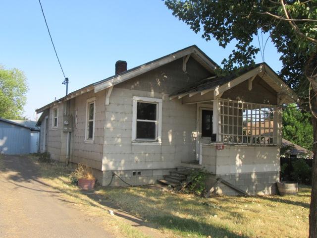 814 sq ft 2 bedroom 1 bathroom Bungalow style home with Laundry off Kitchen, detached 1 car garage, and large finished detached bonus room with electricity. Deep driveway will hold several cars tandem. Great shade tree and fabulous grapevine. Partially fenced. Needs paint, flooring,  and heat. Being sold as is.