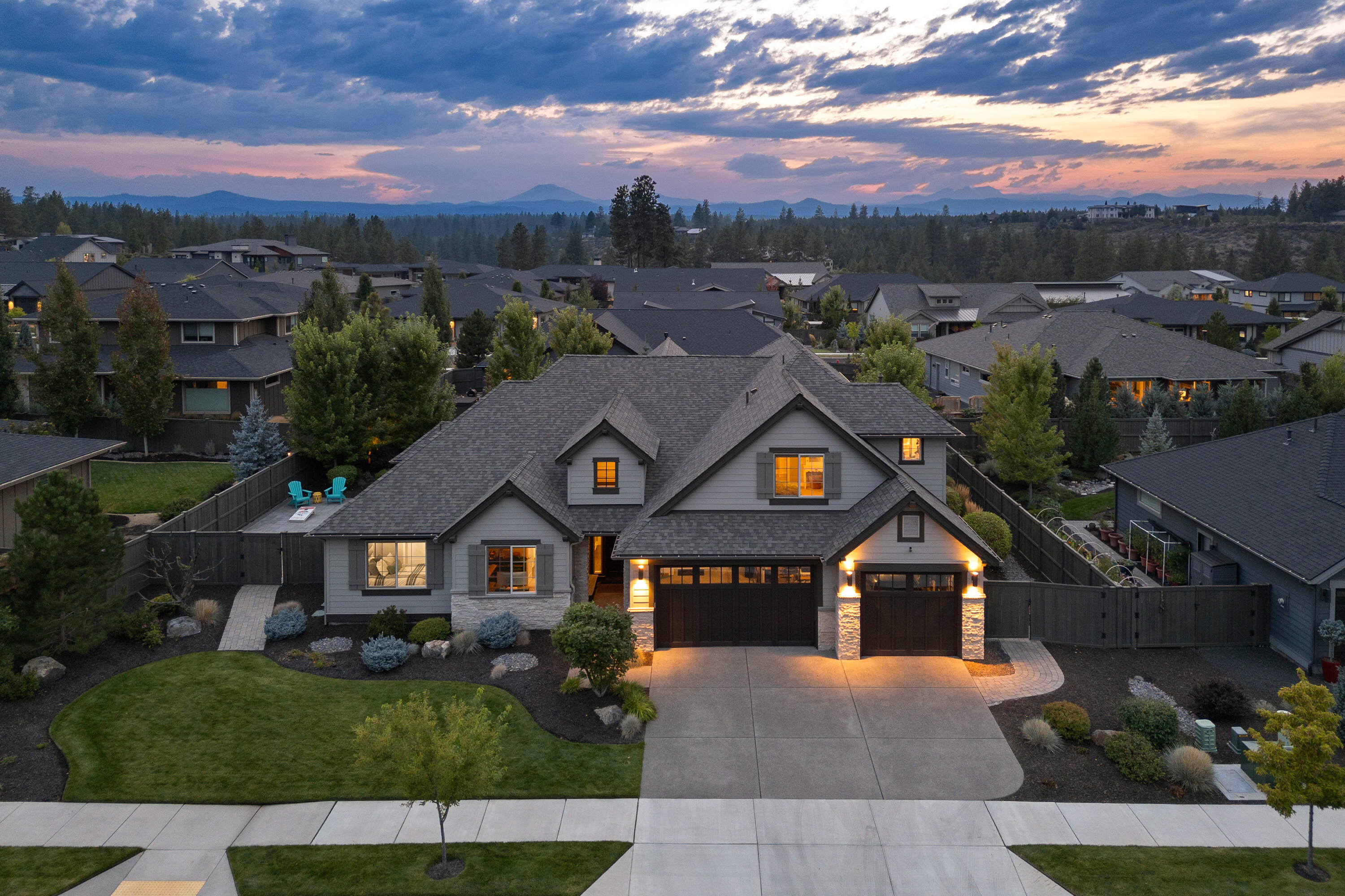 Experience luxury living in this stunningly customized River Vale home in SW Bend. The expansive great room boasts vaulted ceilings, a spacious dining area, and a chef's kitchen with a walk-in pantry, perfect for entertaining. The elegant primary suite features a spa-inspired bath, oversized shower, soaking tub, and generous closet. On the main level, you'll also find a guest bedroom with en suite, private office, and large laundry room. Upstairs offers a bonus room with Cascade Mountain views plus another guest suite. Step outside to an extraordinary backyard retreat, featuring four-seasons outdoor living with heaters, TV, and automated privacy screens. A 3-car garage with EV charger, numerous smart home features, and a freshly painted exterior complete this better-than-new residence. Enjoy direct access to trails, the Deschutes River, nearby schools, and the Old Mill District.  Embrace Bend living at its finest.