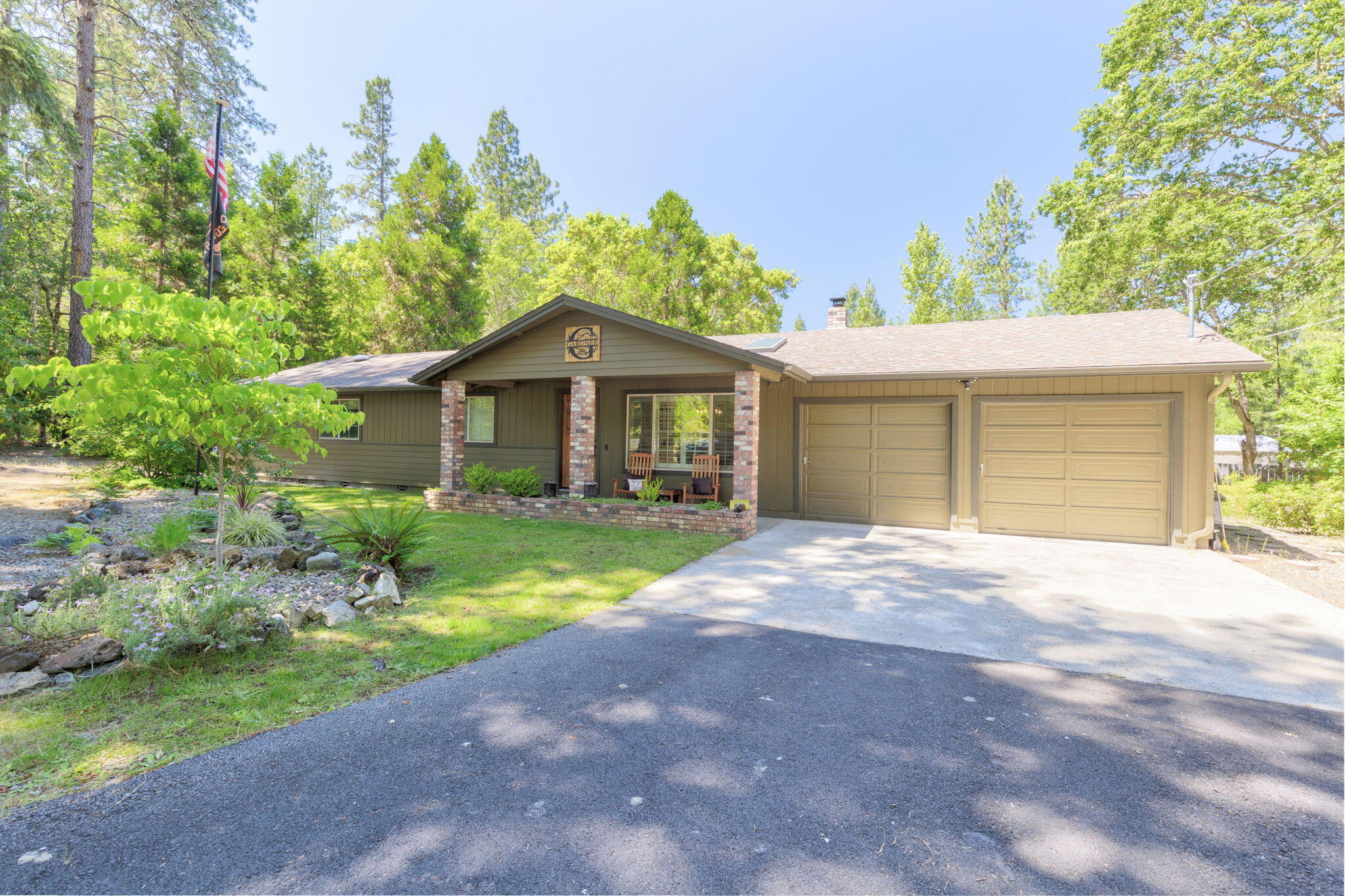 Charming home with a peaceful setting! This home is nestled on a level 1 acre wooded lot providing country living at its finest, yet minutes to town. Step inside the 3b/2b 1,908sf home with a spacious feeling and stunning Canadian maple hardwood floors.  Open floor plan includes a large beautiful kitchen with island, eating area, abundance of quality cabinetry & storage; vaulted ceilings in the living room; plantation shutters; 2 large walk-in closets; wood stove and many other quality features throughout the home. Step outside and relax on the inviting back patio and enjoy the fire-pit.  Mature trees surrounding the property give you great privacy.  The garden area, chicken coop and new shed all add to the country charm.  Enjoy Cathedral Hills Trails located less than 400 yards away. Lots of additional parking for your guests or RV.  This is a perfect place to call home!