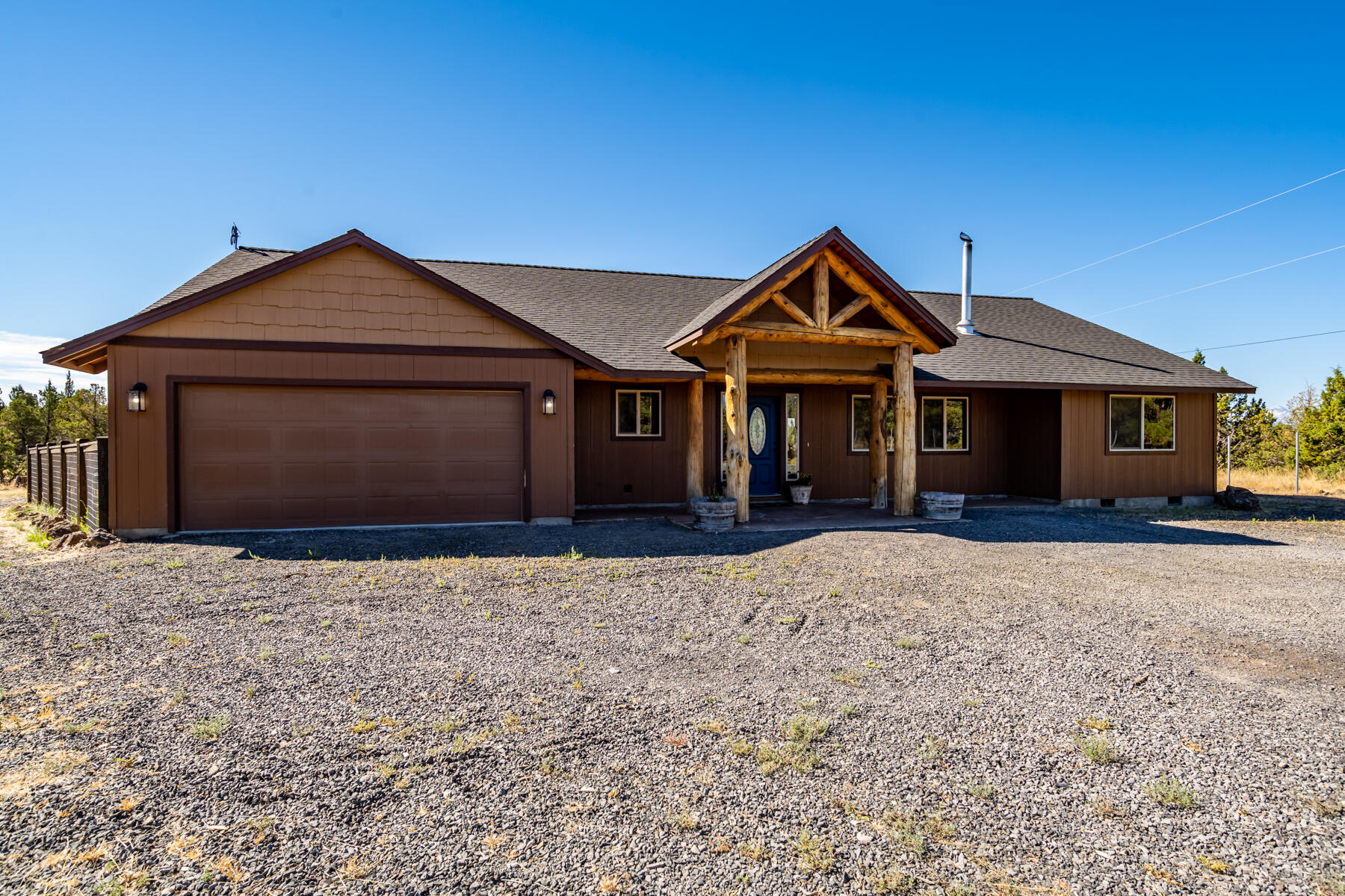 Welcome home to your slice of serene Crooked River Ranch in Terrebonne, OR. This beautiful single level home features open living with a wood burning stove & A/C to keep you comfortable all year long. Kitchen features hickory cabinets, tile flooring, SS appliances, bar seating, & granite countertops. The open floor plan offers vaulted ceilings, river rock hearth, & inlaid barnwood accents. Primary suite has ample storage with 2 walk-in closets, double vanity, & tiled shower. Spacious laundry room with sink leads you to a partially converted garage offering additional room. Outside enjoy the 1.70 acre lot with play structure, multiple outbuildings, fenced dog run, & chicken coop. Log cabin has power & A/C. Lot also features RV parking & power. Come enjoy the peace & quiet with all of the CRR amenities! Including pool, tennis/pickleball courts, 18-hole golf course, RV Park, several parks, baseball field, basketball court, horse arena, & more. Turn key & ready for your personal touch!