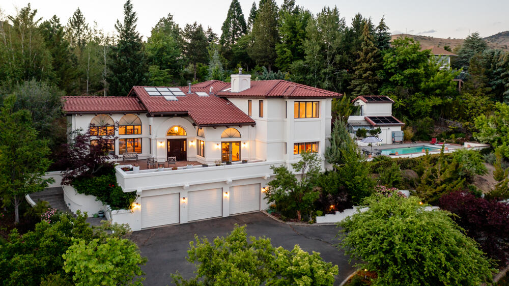 Custom Mediterranean Style, passive solar home with so much to offer! This home is one of a kind offering amazing panoramic views, heated pool, & surrounded by luscious terraced  gardens & landscape. Prime location just minutes from OIT Campus, Hospital, & Downtown Klamath Falls. Featuring 3 stories, 4,683 sqft, 5 beds, 4.5 baths, custom architecture, vaulted ceilings, rustic beams, built in planters & south facing windows providing a bright entry. Formal living with gas fireplace, French doors to private library/office with walk-in vault room. Formal dining with marble top buffet & matching table. Updated kitchen with Borror cabinetry, quartz counters, island with bar seating, new appliances, &open to the family. Off the kitchen is the patio w/ built in BBQ, gas firepit, fully fenced & gated heated pool, greenhouse, & private deck with hot tub off the Primary Suite. 1800 sqft garage utility room/wine cellar & space for 6 cars. *SEE ATTCHED DOCS FOR MORE DETAILED DESCRIPTION*