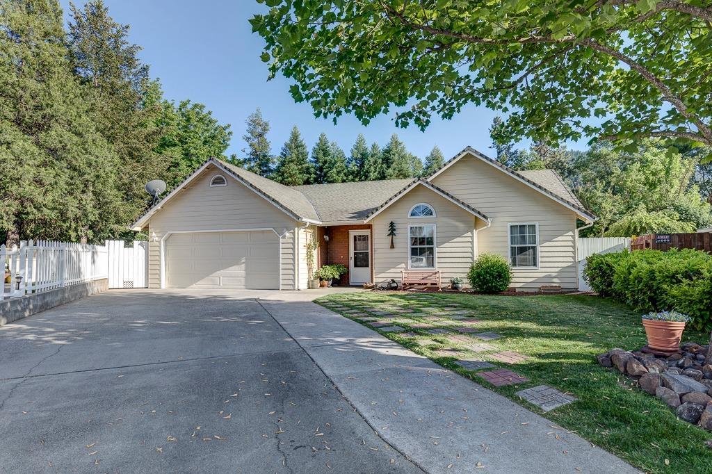 This wonderfully charming home is located on a mature cul-de-sac in a quaint neighborhood in Rogue River. A meticulously well maintained home, it features 3 bedrooms and 2 bathrooms, has beautiful wood grain laminate flooring, open flow spaces from the kitchen to the living room and vaulted ceilings throughout. The master bedroom features a ceiling fan, double sink vanity and access to the back deck. Enjoy relaxing in the 13' x 11' screened-in porch area year round, or enjoy sitting under the pergola covered outdoor seating area with a piped natural gas fire pit area, natural gas is piped in for your BBQ as well and the backyard features a new large wood deck that is 14' x 26' for outdoor eating or to add a spa off the master bedroom. Enjoy the mature landscaping has been well maintained and features, fruit trees front and back grass areas, along with a raised garden area, this home is truly turnkey ready for you. This home comes with a 1 year home warranty from Fidelity.