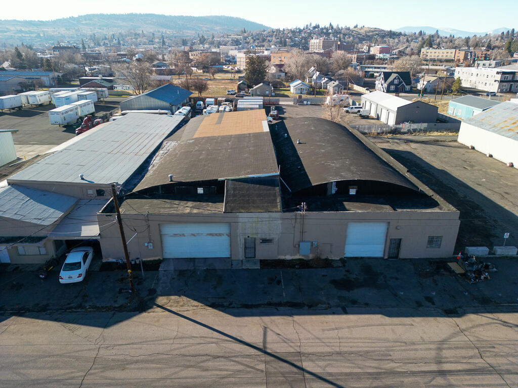 Multi-building industrial complex on two parcels with 20,299 sq ft of warehouse and office space at 300-320 Market St, Klamath Falls. Parcel 1 features twin units (300 & 310 Market) with 12' ceilings; Parcel 2 offers 6,534 sq ft with tall shed roof and office/bathroom. Spaces can be utilized individually or together, ideal for multi-tenant occupancy, storage, distribution, light manufacturing, or owner-occupier use. All three buildings currently rented month-to-month at $1,500 each, providing immediate income. Prime location with easy access to US-97 and OR-140, perfect for investors or businesses seeking industrial space in Klamath Falls.