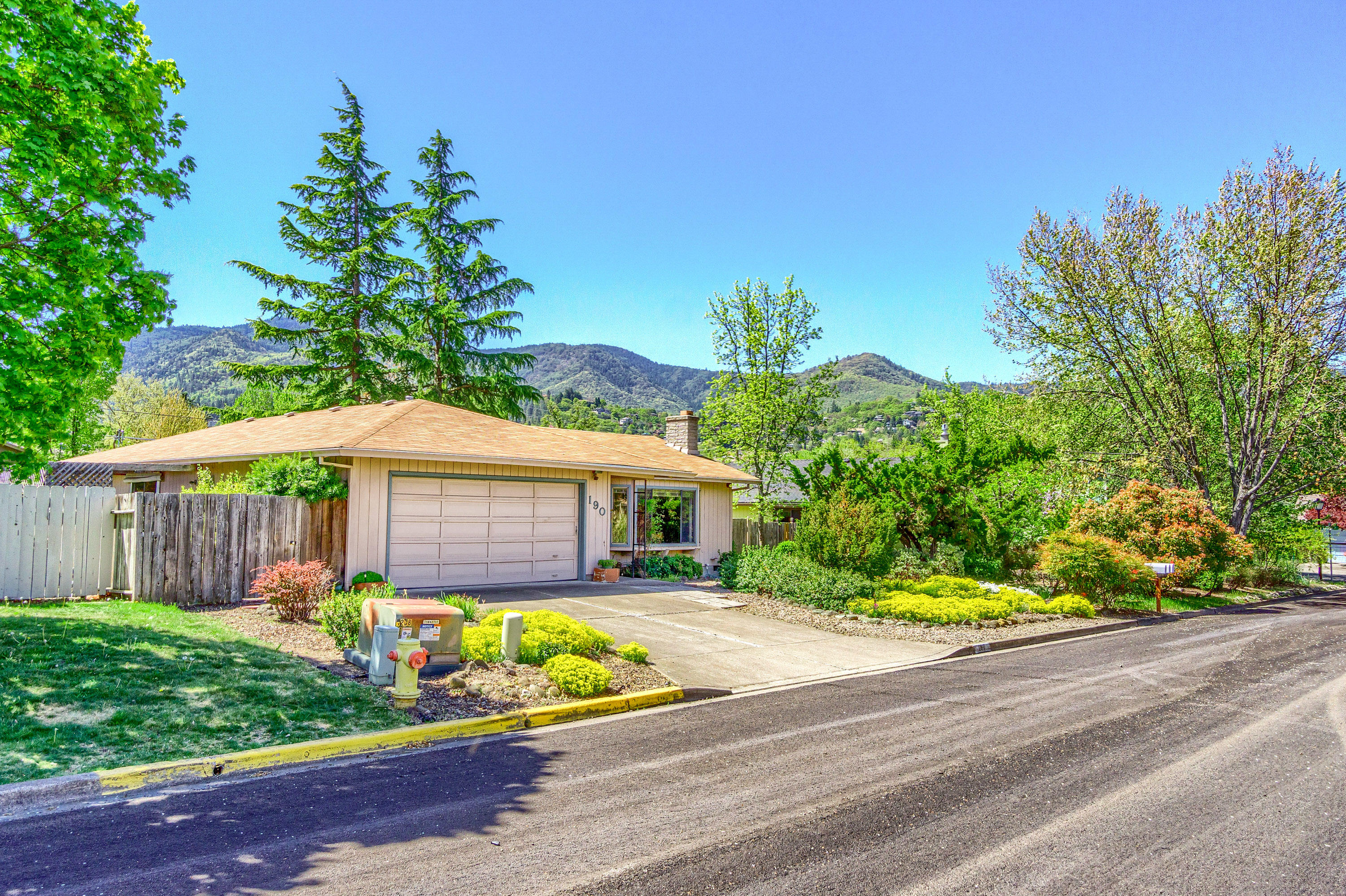 Original owner is offering this solidly built, single level home in a fantastic Ashland neighborhood. This three bedroom, two bathroom home sits on a level lot that is close to Helman Elementary, dog park, and the greenway bike path. It is only 1.1 miles to the plaza, providing easy access to downtown Ashland's shops, restaurants and Lithia Park. The spacious living room features a wood burning fireplace surrounded by natural rock and great natural light, which is provided by the oversized window. The bedrooms are separated from the main living space, creating privacy and quiet. The primary bedroom has an en suite bath and a sliding door that provides direct access to the backyard patio. The home provides wonderful views of Mount Ashland from the kitchen window and Grizzly Peak view from the front yard.
