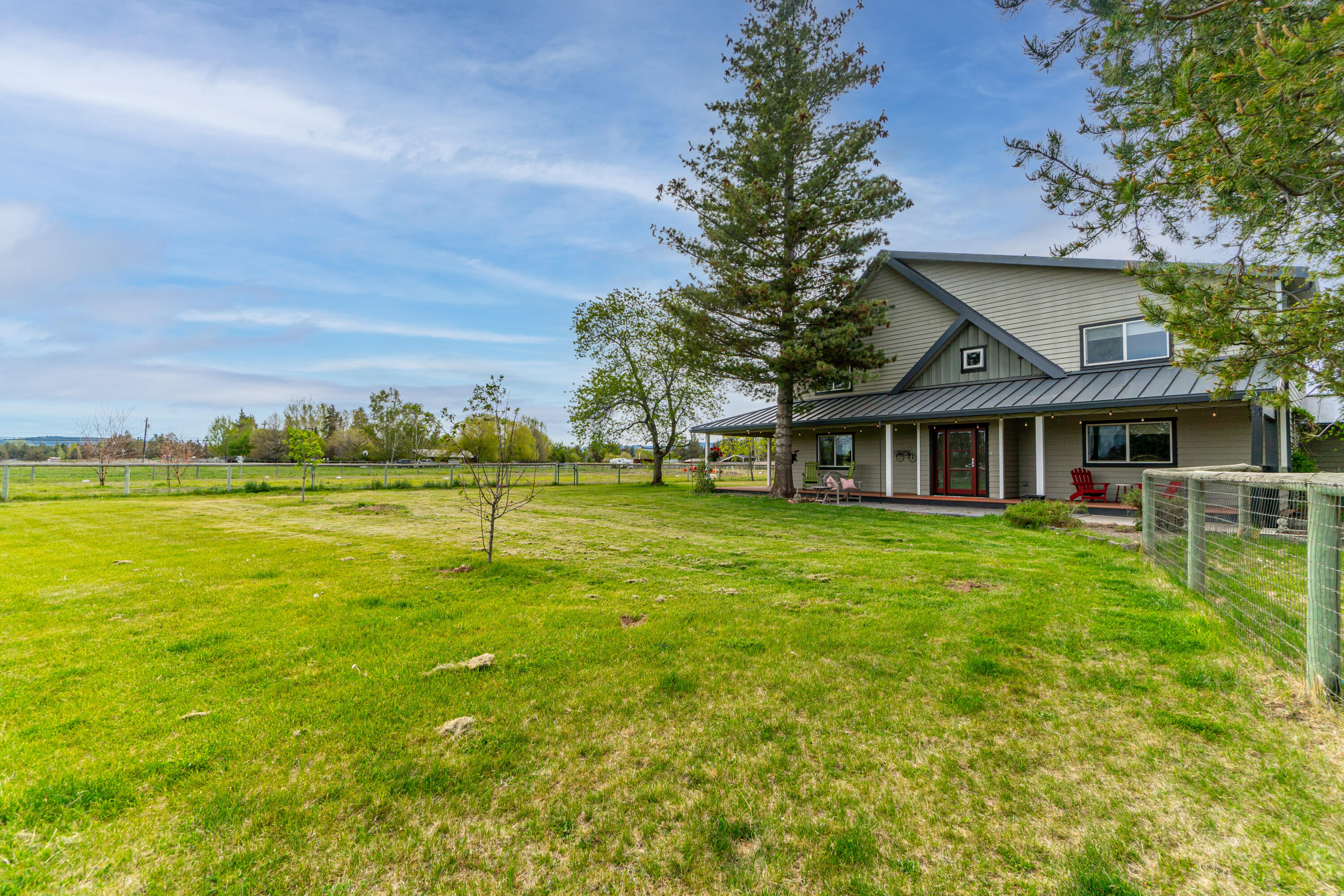 Lovely, spacious home on Tumalo acreage with a charming pond, multiple shops & barn! This inviting property features an open floorplan with abundant windows & new
glass doors that open onto a wraparound porch, creating a special connection with the beautiful setting. Enjoy the mountain views from the bucolic setting with 2.5 acres
of Swalley irrigation. The main level has a large kitchen & great room, ideal for entertaining. The home has a gracious master suite with newly remodeled, spa-like bathroom and two guest bedrooms upstairs. Additional guest quarters, full bath and large bonus room with separate entrance are on main level. With a den, living room, sunny
great room & even a gear room, this house has space for everyone! Large shop for your projects and adorable barn for true country living, yet close to town & shopping...come live the Central Oregon dream!