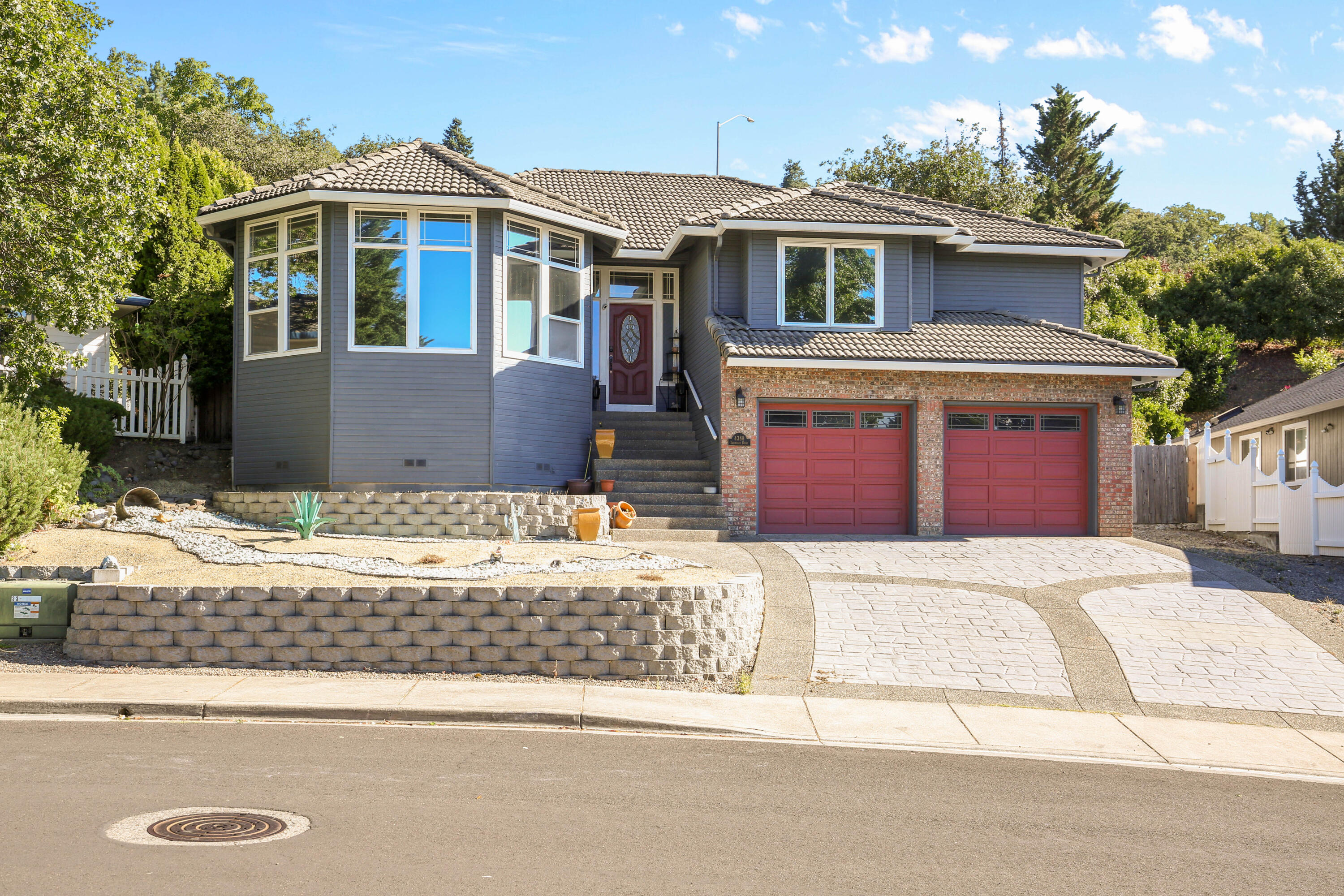 Updated East Medford home in the Oregon Hills neighborhood with incredible views of the city and valley. The main level offers an open layout with high ceilings, a sunken living room with a fireplace, and large bay windows. Kitchen includes granite counters, gas range, double ovens, and a breakfast nook with backyard access. Three bedrooms and two full bathrooms on the main floor, including a primary suite with walk-in closet and updated bath with double vanity, walk-in shower, and soaking tub.

Downstairs includes a second living area with wet bar, new flooring throughout, an additional room for office or potential 4th bedroom, and a full bathroom. Covered deck overlooks a landscaped yard. Oversized insulated garage with tandem third bay, shop space, and large storage area. Recent exterior updates include new paint and gutters. Possible two-family setup.