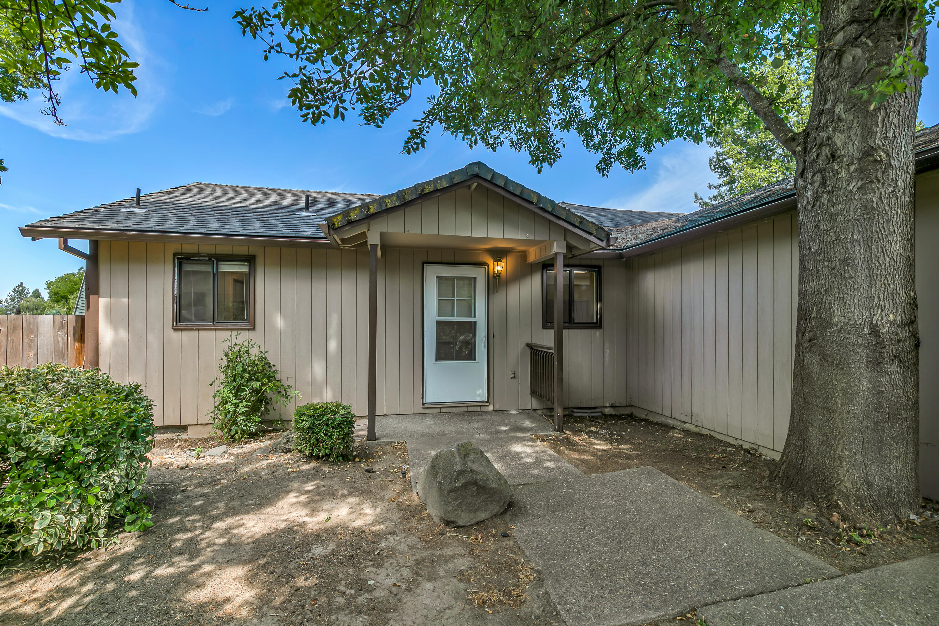 Opportunity Awaits! This 3-bed, 3-bath, 2,132 sq ft home is full of potential. Located in a cul-de-sac in East Medford, this home features a spacious floorplan, with two separate living areas and two bedrooms with en suite bathrooms. While the home could use some updates, key improvements have already been made, including a repaired foundation and a newer water heater. Enjoy a large, fully fenced backyard that is a blank canvas for your future garden! Potential for RV parking in the side yard, along with a 2 car garage, means space for all your vehicles. This home is a fantastic opportunity to create your own vision. Don't miss out on this deal!
