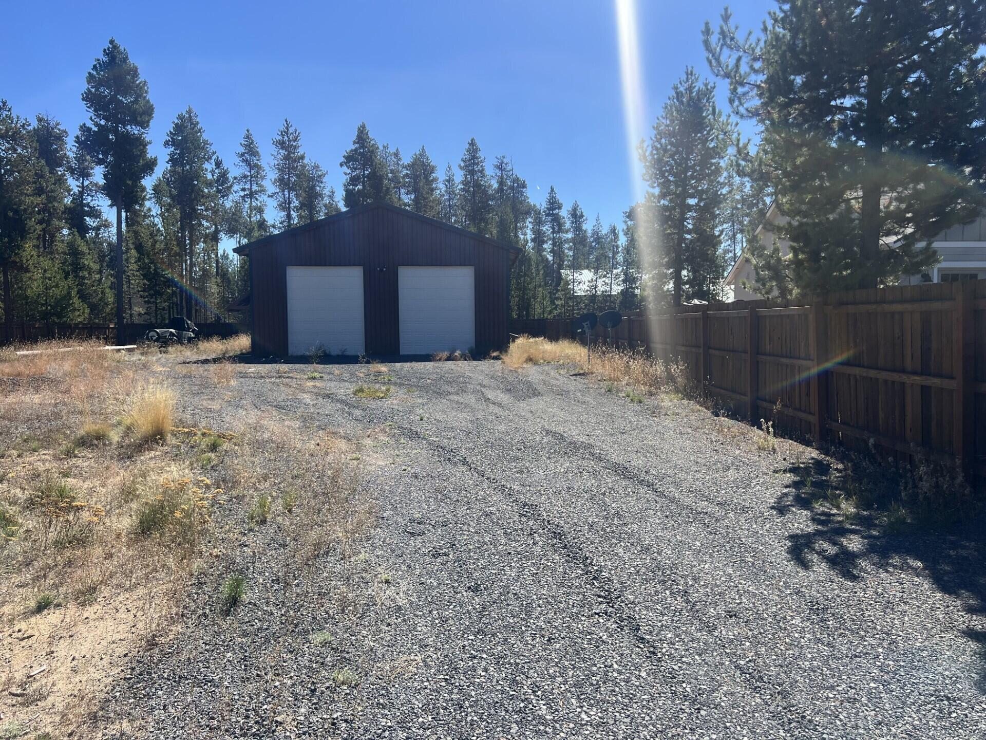 Looking for a 1/2 acre lot fenced with a well and power ready for your getaway place. This shop and 1/2 acre lot are in an area of new construction homes and just minutes to Mt. Bachelor, High Cascade lakes and Sunriver. This area gives you access to the Big Deschutes river just down the road to the DRRH Unit #9 park and boat ramp. The 1920 sq. ft. shop has lots to offer 40x48 with large RV doors and a man door to enter the shop. The pictures will give you a great ideas what you can use the shop for storage ore remove the walls for all your outdoor toys. This is well set up for craftsman or arts and crafts with several rooms designed within the shop.  Come take a look at what this property has to offer.