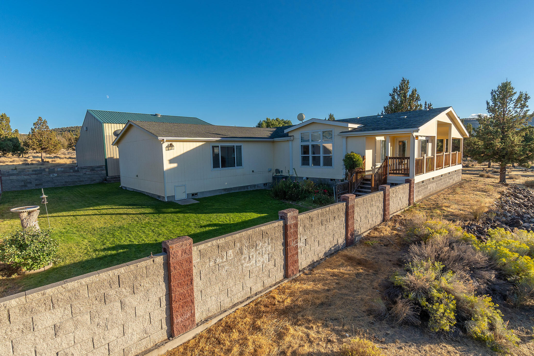 Country Living close to town on 2.3 ac. positioned to enjoy Cascade Mt & Valley Views. Lovely well- kept home built in 2001 w/ 1860 Sq Ft SHOP, heated & large enough for RVs & toys plus enclosed storage room above & adtl 3rd bay. Triple wide Good Sense MFG Home, 2872 Sq Ft, 3 bedrooms, 2 baths, vaulted 10' ceilings living rm & family rm w/tray ceiling, plus large bonus/flex room could be another bedroom, studio, office or in-law suite, w/separate entrance. Spacious open efficient kitchen, sm island, eating bar, pantry, great counter space & plenty of cabinets. Open dining room positioned with living room on one side and family room on other side, offers lots of natural light w/access to large, covered deck or access the cozy backyard. Nicely landscaped, minimal upkeep w/ concrete block fenced back yard, paved driveway & private end of street setting. Great location facing the Setting Sun!