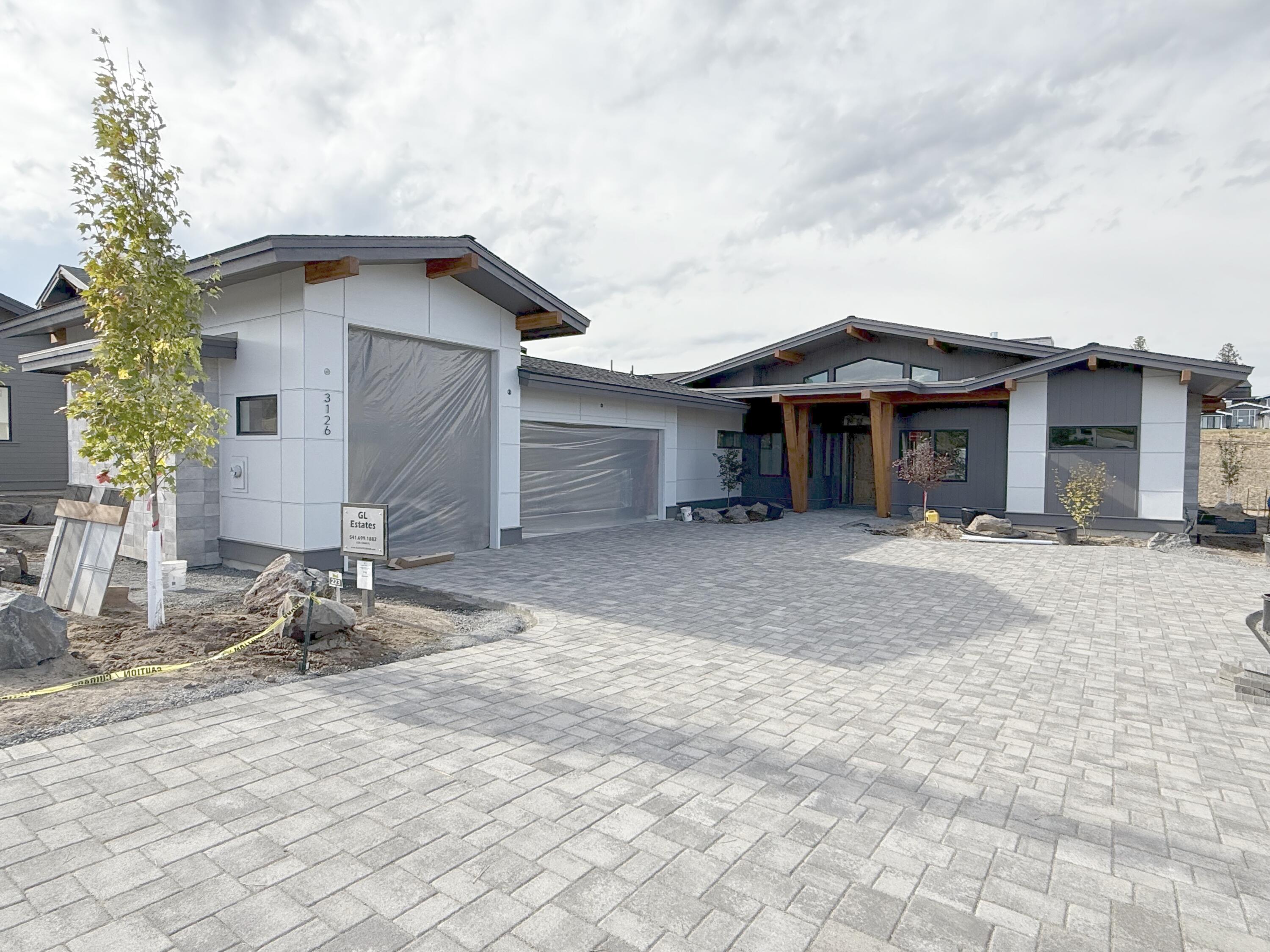 Far from your typical spec home, this single-level residence offers custom-caliber finishes in a stunning setting. A modern mid-century aesthetic is elevated by premium siding panels, an XL paver driveway, and extensive beam work front and back. The distinction continues inside with 24x24'' Italian tile in all bathrooms, floating cabinets, backlit mirrors, and dropped showers with infinite drains. The great room offers indoor/outdoor living through three-panel sliding doors that open to a patio with hot tub prep and screening, all backing to 15+ acres of green space and trails. In addition to a catalog-worthy primary suite, the home includes two additional en-suite bedrooms, a dedicated office, and a fourth bedroom that can serve as a den, gym, or media room. Need space for gear? You'll appreciate the oversized three-car garage with Sprinter bay. With completion expected before Thanksgiving, now is the time to secure custom design, premium finishes, and exceptional Westside access.