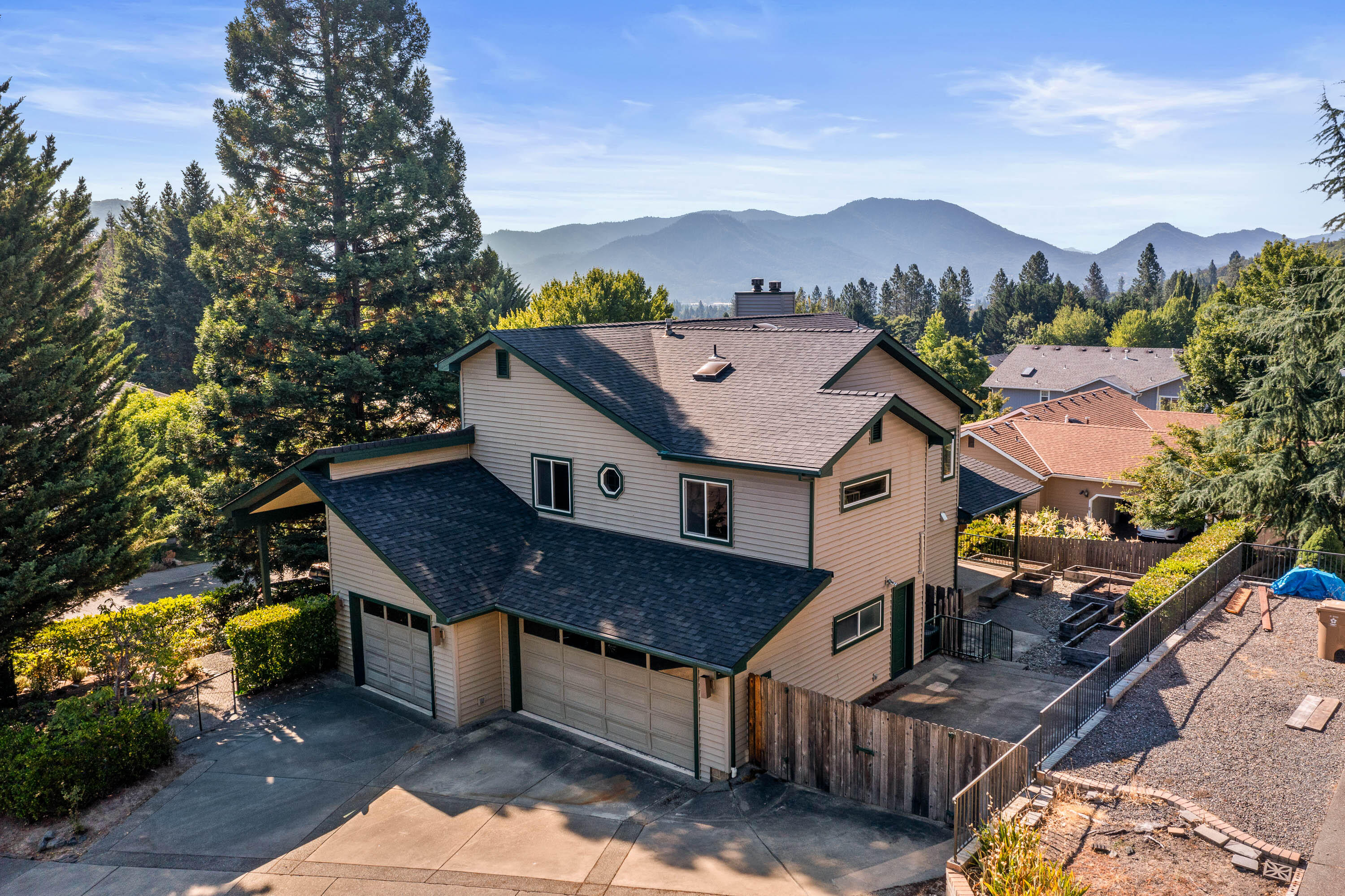 Located in one of Grants Pass' most highly desired NW neighborhoods, this beautifully maintained 5-bedroom, 3-bath home offers generous space, thoughtful design, and stunning views. The spacious kitchen is a chef's dream—featuring a large island, ample cabinetry, double ovens, and a pantry for excellent storage. The primary suite is a luxurious retreat with a fireplace, double vanity, soaking tub, and private water closet. Enjoy a large laundry room, 3-car garage, covered patio, and raised garden beds—perfect for outdoor living. Brand new LVP flooring and freshly painted interior make this home move in ready and ready for YOU! This home combines comfort, function, and style in a prime NW location. Hurry, this one won't last long!