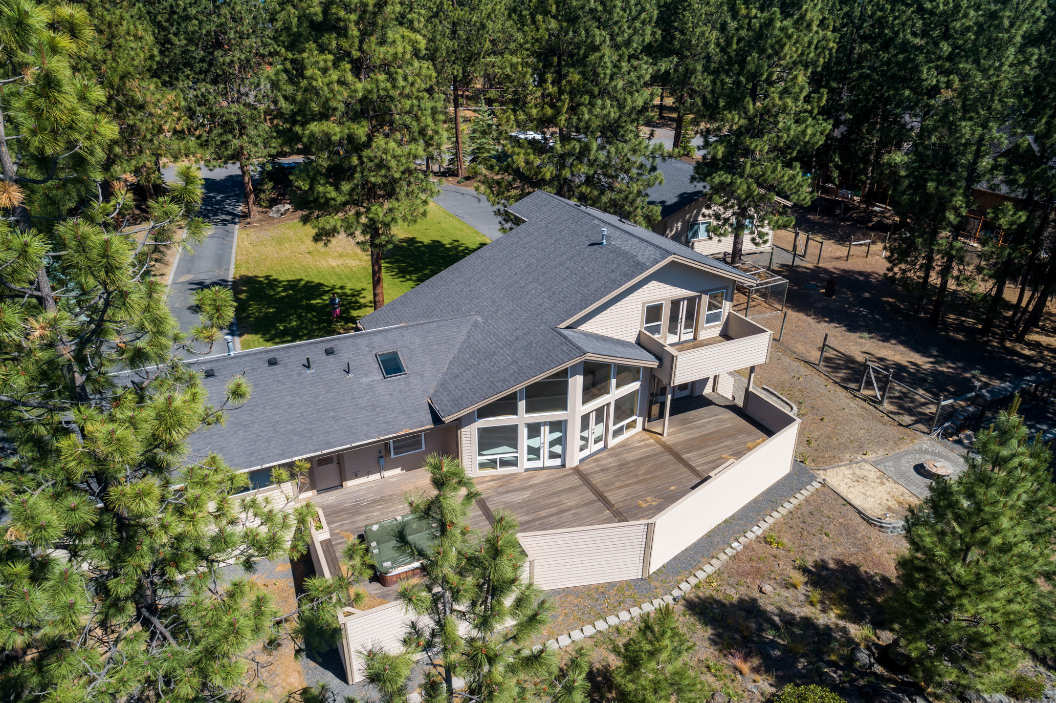 Situated high on the Rimrock above Century Dr on the way to Mt. Bachelor, this private setting offers mature pines & landcape on nearly an acre of prime west Bend property. A true custom home, this unique floor plan features a prow front wall of windows to capture spectacular views of the tree tops. Open living space w/soaring 2 story vaulted ceiling, natural wood trim & accents throughout. Spacious Master Ste has a private deck & oversized bath. Expansive deck off the Great Room makes entertaining a lg party comfortable! Attached dbl car garage 
 paved drive. You'll enjoy the heated 1,800 shop year round - with space to store all of your toys & have a work space too w/tons of built in cabinetry. Vaulted ceiling in part of the shop for taller RV access. Just minutes from downtown Bend, Phil's Trail, Alpine Park & Tetherow. Live & play here - or subdivide w/potential to create 4 individual home sites. Don't miss this one!