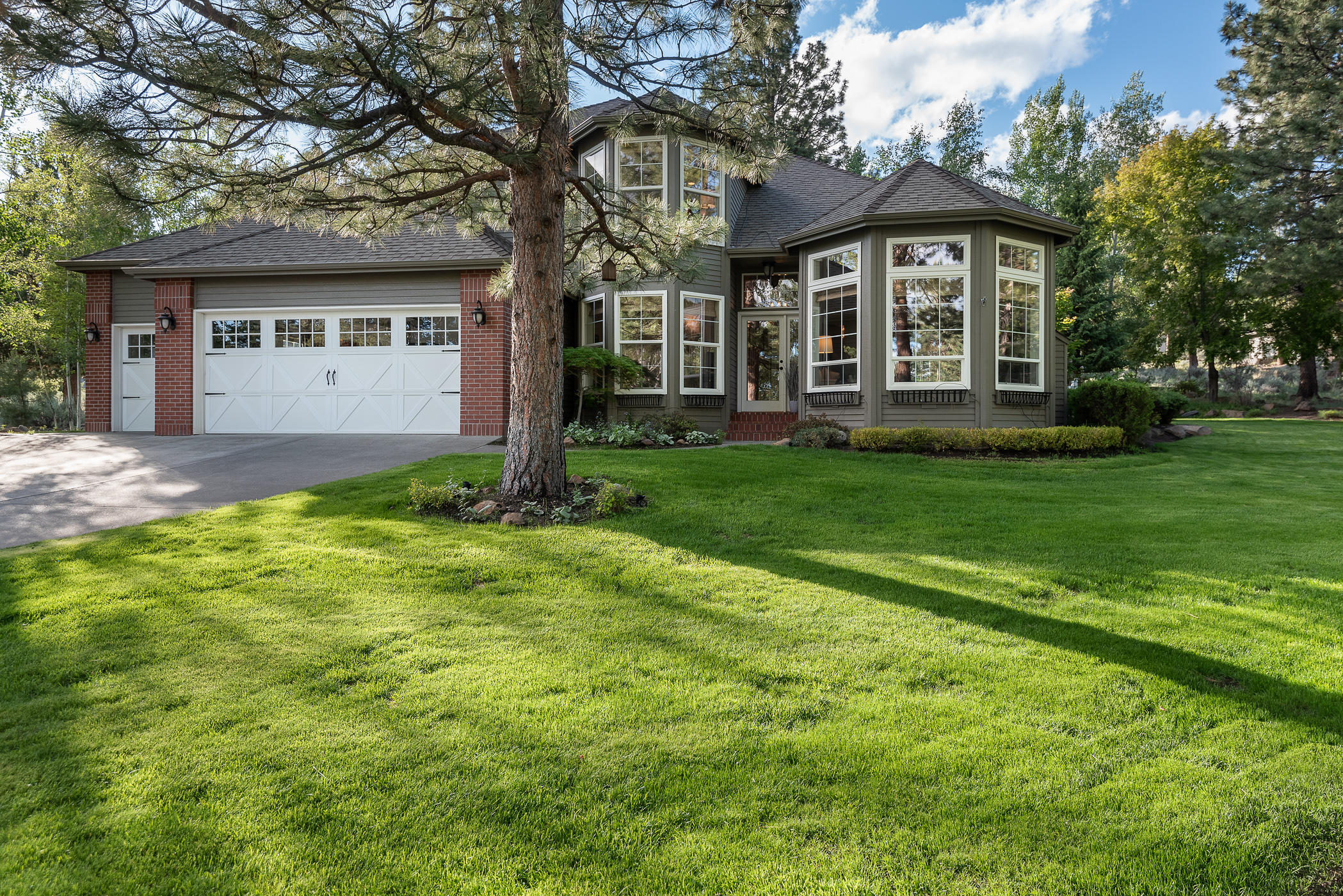 New Price Improvement! Located in the coveted NW section of Bend, this rare offering affords the ultimate open floor plan w indoor-outdoor flow, ample light throughout & inspiring outdoor spaces. Designer kitchen, eat-in kitchen area & adjoining great room open to the backyard. Expansive formal living room, dining area, full bath on the first floor, in-laundry room with sink and attached access to the oversized three-car garage complete w epoxy flooring. The primary suite sanctuary lends itself to be a peaceful, light-drenched space, with a luxurious en-suite full bath, updated to include an oversized shower, double-sink vanity with ample storage & walk-in closet. The second floor offers large scale bedrooms w a stylish shared full bath. Sited on 0.69 acres, the grounds include lushly landscaped gardens, al fresco dining area appointed on the oversized deck is optimal for entertaining. Close to best hiking & biking trails, Newport Mkt, Restaurants & the award-winning Bend Schools.