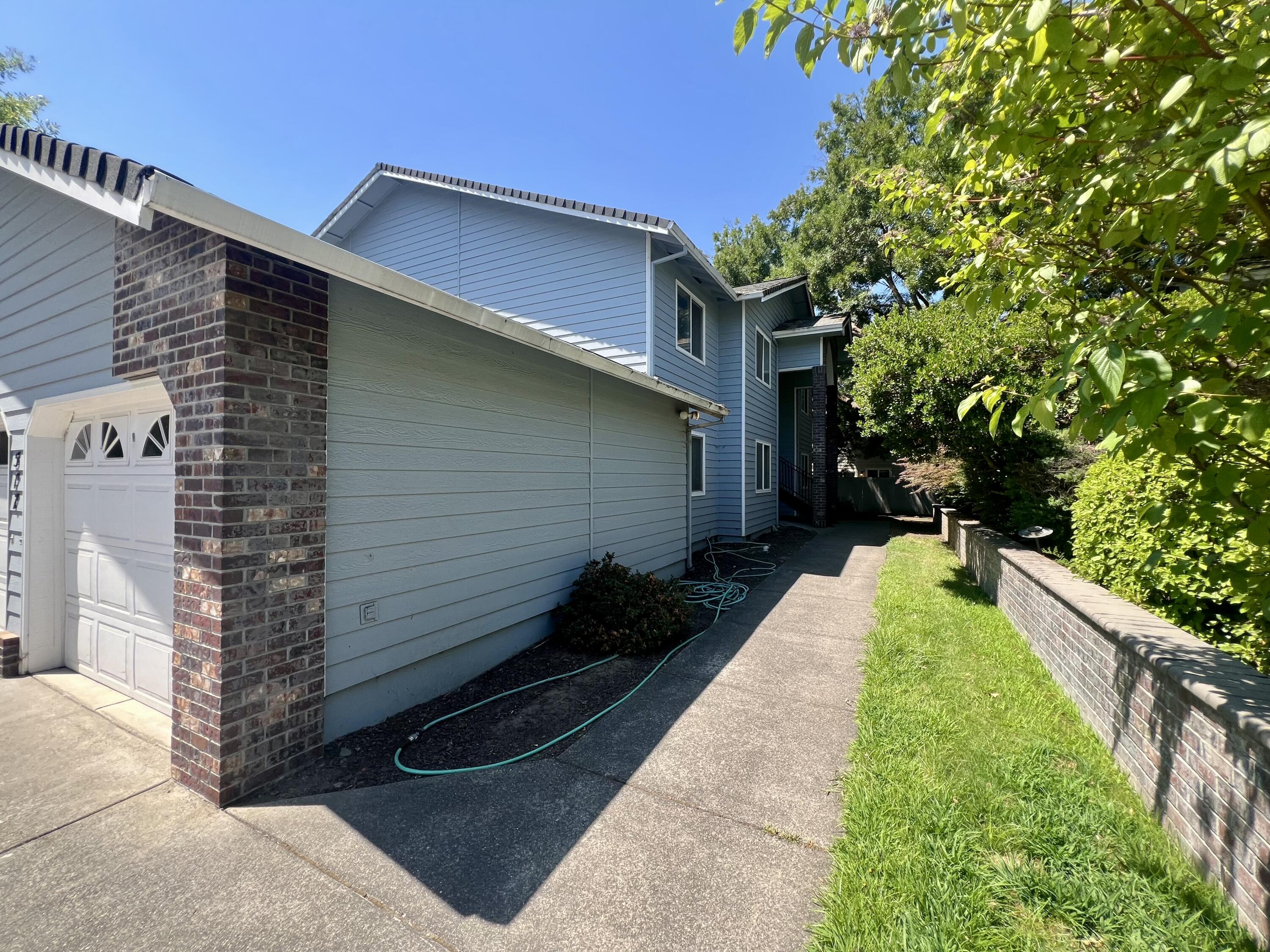 Attractive 1996-built quadplex in a well-maintained Central Point neighborhood. This 4,232 SF two-story property features a brick-and-siding exterior, mature landscaping, and a wide driveway with private single-car garages for each of the four 2BD/2BA units. All units have separate gas/electric meters, no HOA fees, and professional management. Current rents are $1,295/month per unit with long-term tenants in three units (since 2016 and 2018). Located near Crater High School, Don Jones Memorial Park, and shopping, with quick I-5 access to Medford and the Rogue Valley International Airport. Potential to increase gross rental income over time.