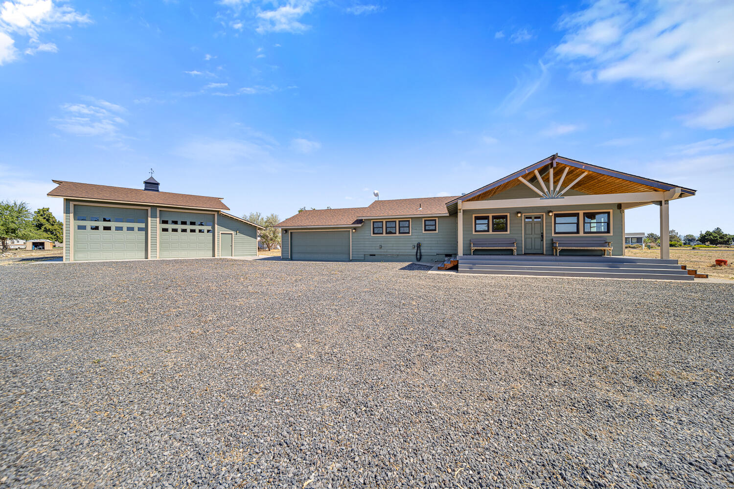 Adorable and full of charm, this unique home is packed with character! From the tongue-and-groove woodwork to the copper countertops, oven hood, and hand-pounded copper walls behind the wood stove, every detail shines. The spacious primary suite boasts vaulted ceilings, French doors to the Trex deck and hot tub, and a spa-like bath with a freestanding tub, walk-in shower, and on-demand hot water for endless comfort. Pendleton curtains add both style and energy efficiency throughout.
The property also features a fully insulated 2-car attached garage plus a large 30.6 x 38.6 insulated shop with 14' roll-up doors—perfect for storing your boat and toys, with Lake Billy Chinook's boat ramp just minutes away. Whether you're seeking a full-time residence or a weekend getaway, this home has it all. CC&R's allow up to 2 horses.