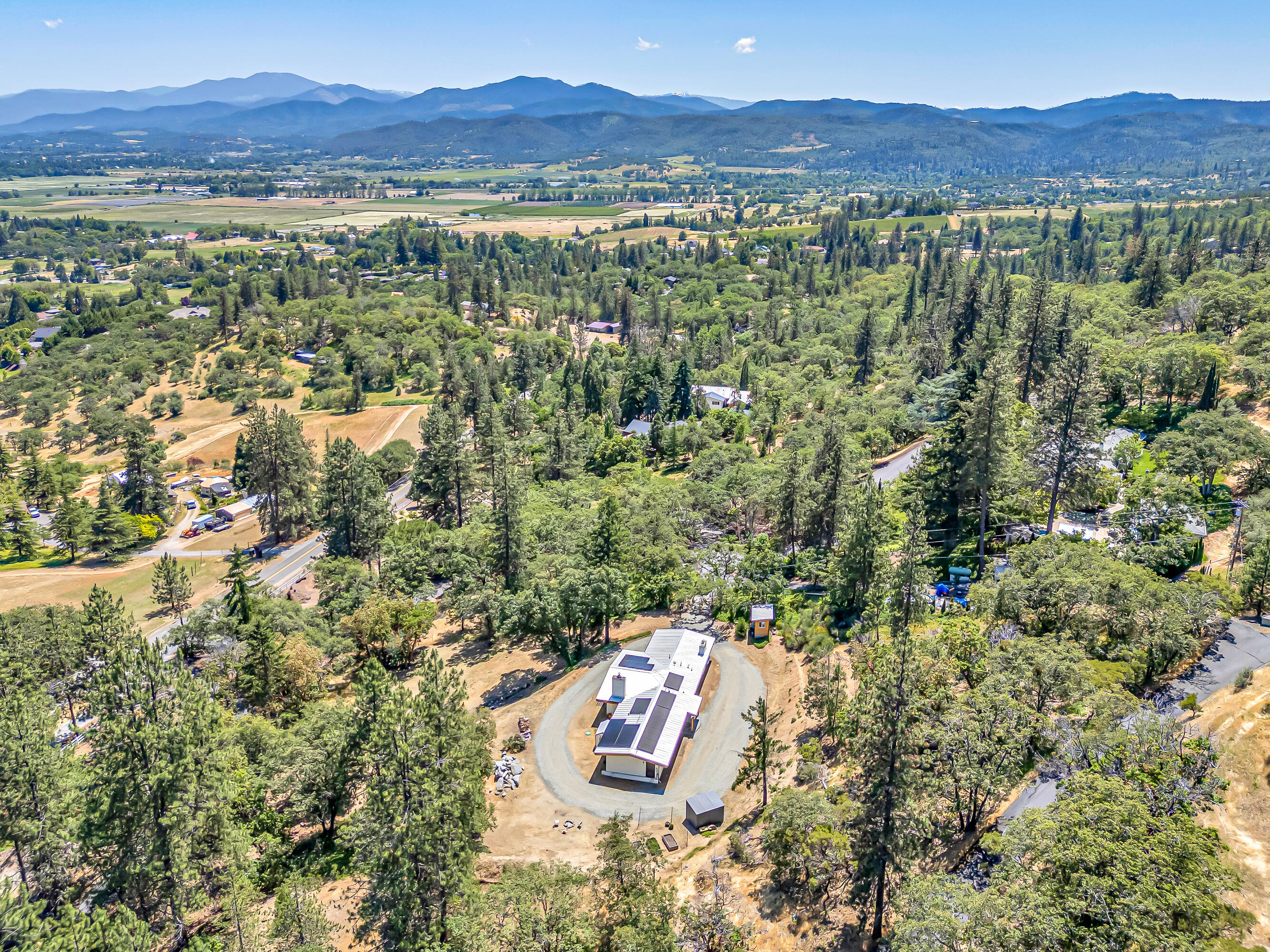 Discover this stunning single-level home located just minutes from the charming 
town of Jacksonville, situated on the highly desirable Old Military Road. Set on a private, 
gated 0.98-acre lot, this serene property offers captivating views of Mt. McLoughlin, with vibrant sunrises, colorful sunsets, and frequent wildlife sightings adding to the tranquil atmosphere. A picturesque tree-lined driveway welcomes you to a thoughtfully updated 3-bedroom, 2-bath residence. Inside, enjoy a beautifully remodeled kitchen, luxurious master bath, and updated laundry room. Recent improvements include a new electrical panel, recessed lighting, and a new septic system (2019). Energy-efficient features abound with solar panels, newer mini splits in every room, a newer wood stove for cozy winter nights, and an EV charger. Offering peace, privacy, and proximity to town, this home is the perfect blend of rural charm, modern convenience, and sustainable living.
