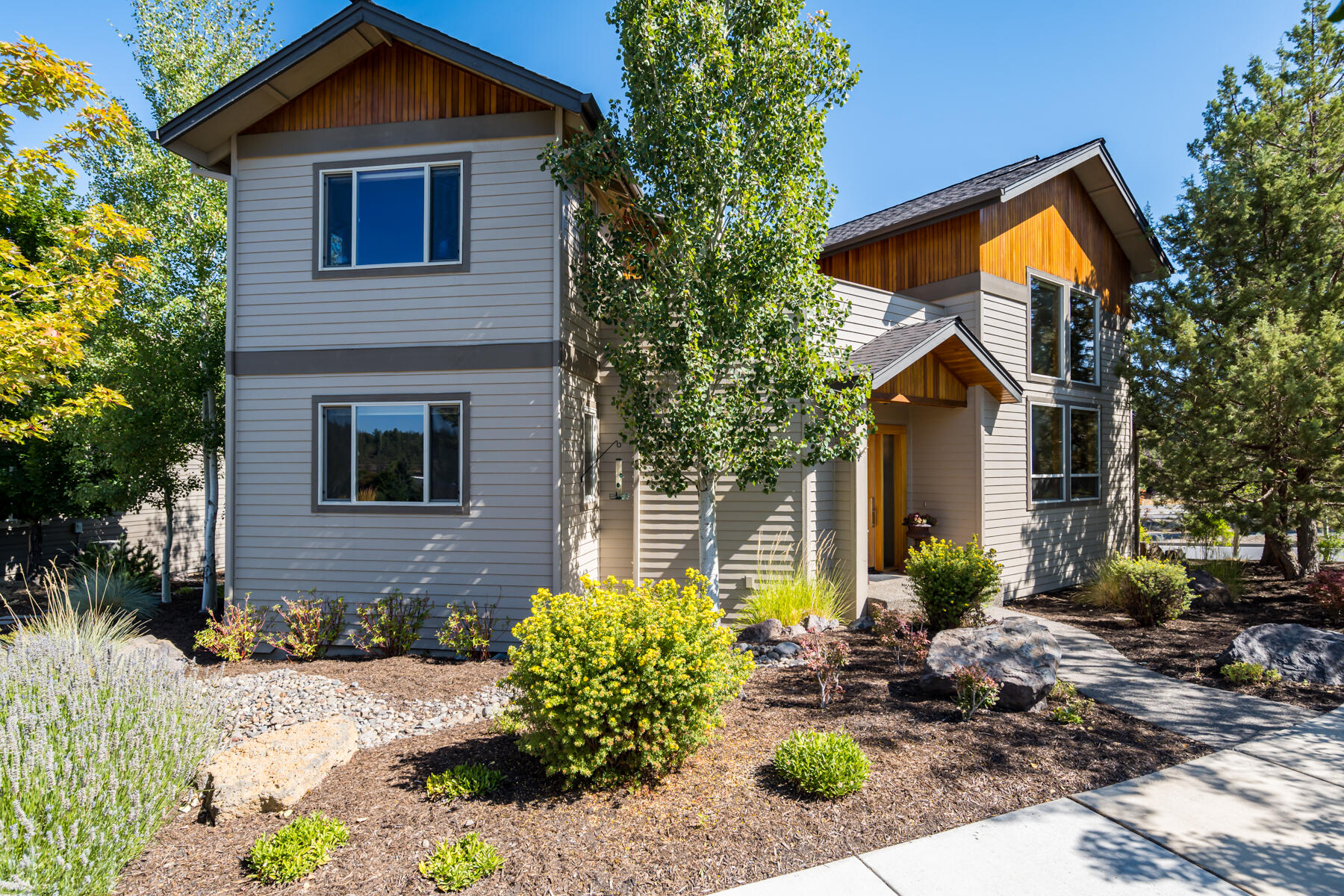 Meticulously maintained custom home in Shevlin Reserve with Cascade Mountain views! Modern style with open great room plan, wonderful natural light, high ceilings with large windows & gas fireplace. Kitchen boasts large window directly facing Mt. Bachelor, maple floors, custom cabinets, tile counters & backsplash, stainless steel appliances, pantry and breakfast bar. Dining area with maple floors and slider out to a cozy deck surrounded by Aspens. Spacious main level master features walk-in closet, large bathroom with double vanities, jetted tub with tile surround, large tile shower, tile counters & backsplash. Upstairs features a family room, 2 bedrooms, full bath, and an overlook walkway leading to a fabulous studio/office with mountain views. Two upper decks for your enjoyment. Easy care landscaping front and back. Oversized 2-car garage with large, dedicated storage room. Close to schools, Discovery Park, Shevlin Park, trails/bikeways, and the Northwest Crossing shopping district.