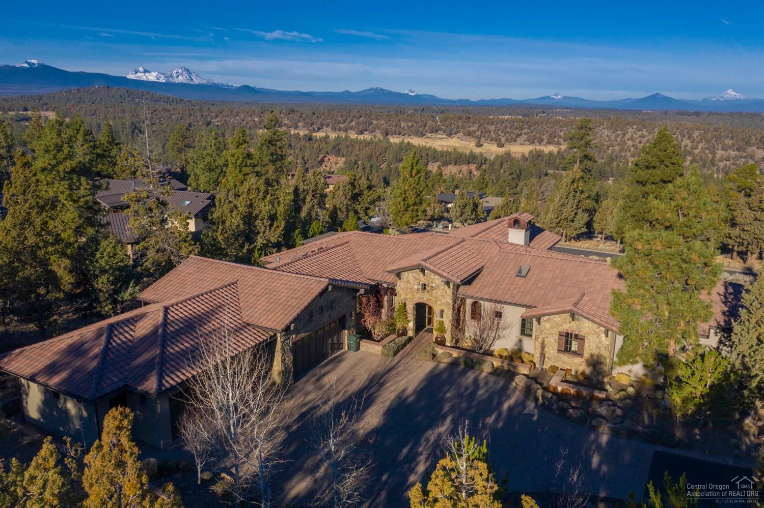 Exquisite one level custom home in the desirable, gated North Rim community with expansive Cascade Mountain Views. Unparalleled quality construction with stone, stucco, brick and wood beam accents. A perfect floor plan with a huge great room with limestone surround fireplace, tall vaulted wood ceilings and walnut wood floors. Grand Chef's kitchen highlighted by Wolf range w/custom limestone vent hood, large center island with granite counter top w/built-in butcher block cutting board plus breakfast bar seating. Den/office with Alder cabinetry & built-in desks w/marble tops. Beautiful master suite w/ his & hers baths w/sauna and large walk-in closet with many built-ins. Exercise/bonus room with outside access and potential to convert to additional guest suite. Plus a 4+ car garage.