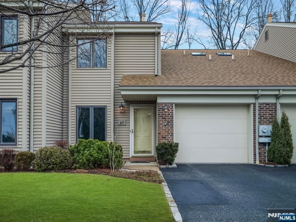 Welcome to this charming 2-bedroom, 2 1/2-bath townhome that offers both comfort and convenience. Located just moments from Rt. 80, Saddle River Park, and local shopping, this home provides a double-height grand foyer with an ideal blend of tranquility and accessibility. The spacious living room features a cozy fireplace, creating a perfect ambiance for relaxation, while the adjacent dining room is perfect for entertaining. Sliding glass doors lead out to your private patio, extending your living space outdoors. Upstairs, you'll find a convenient second-floor laundry room, making laundry day a breeze. The main bedroom offers a walk-in closet, and an en-suite bath, and a second full bath is available for the second bedroom and guests. Additional highlights include an attached one-car garage, providing easy access and extra storage space. With proximity to walking and biking paths in Saddle River Park, you'll enjoy endless opportunities for outdoor recreation. Don't miss out on this wonderful townhome, schedule a tour today!