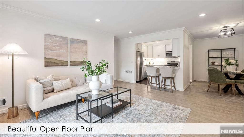 This beautifully updated 2-bedroom, 2-bath condominium in the desirable Society Hill community of Mahwah. This move-in ready home features a stunning newer kitchen with quartz countertops, stainless steel appliances, and a convenient breakfast bar that opens seamlessly to the spacious living roomâ€”perfect for everyday living and entertaining. Large sliders to the balcony offer an abundance of light and sunset views. Updated flooring flows throughout the home, creating a clean, modern feel. A separate laundry room with a full-size washer and dryer adds convenience and extra storage. The corner primary suite with its bay window is bright and spacious and offers a walk-in custom closet as well as a private en-suite bath. The generously sized second bedroom features a wall of closets also including closet organizer. A second full bathroom provides comfort and flexibility. Enjoy the convenience of a dedicated parking space "13A2" along with ample guest parking. Society Hill provides outstanding amenities, including a swimming pool, tennis court, community room, and on-site managementâ€”all with a low HOA fee. Residents also enjoy beautifully maintained grounds and easy access to shopping, dining, major highways, and public transportation. Call Kelly & Till at 914-954-0609 to schedule your private tour!