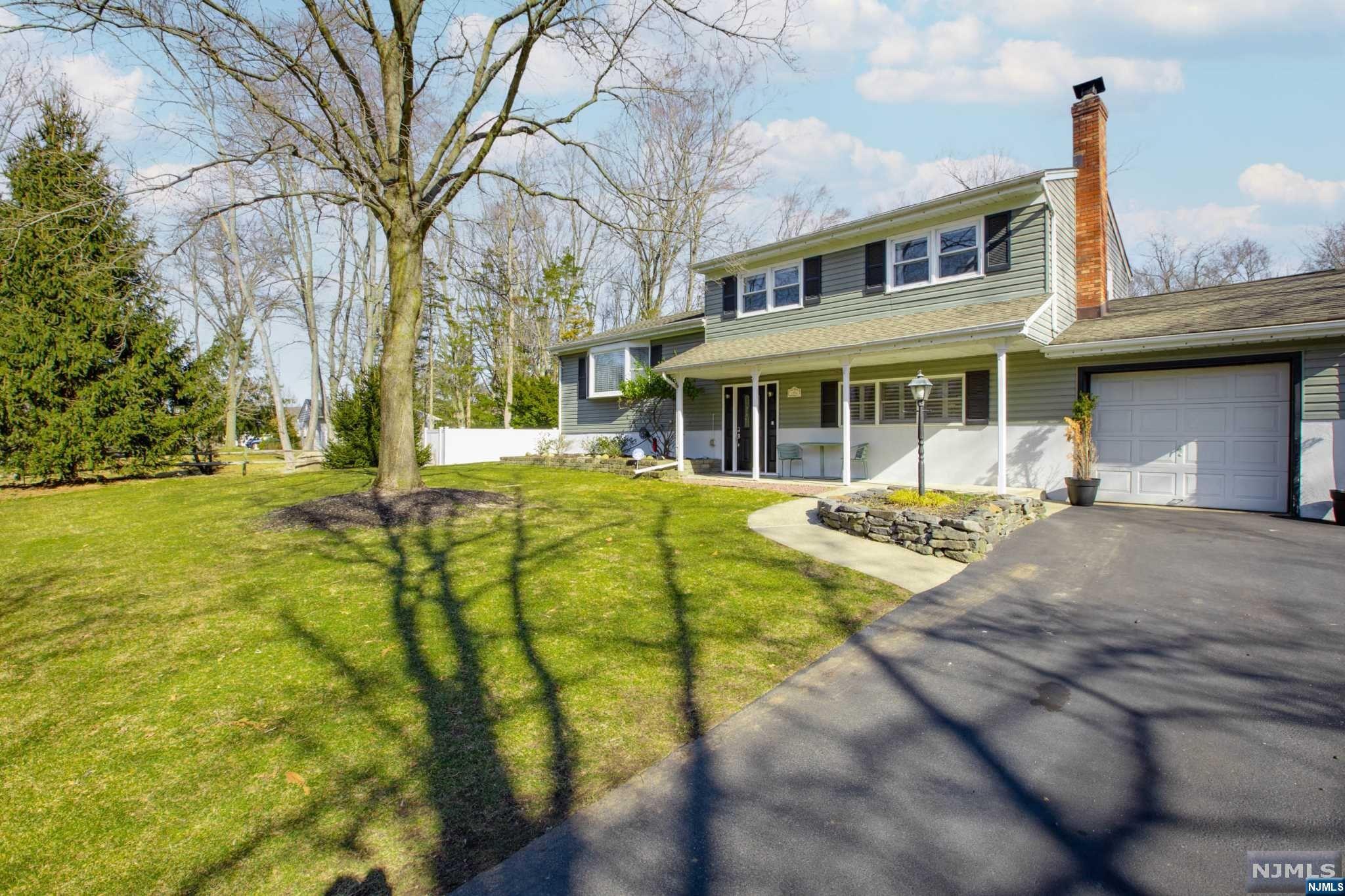 Ideally located is this 2148 sq ft 3 bedroom home with a relatively flat yard on .632 acre! Saunter in from the lemonade porch that opens to the ground level entrance. Steps away is the oversized den with brick fireplace, full bath and a pass-through laundry area. Open the sliding doors to the deck and enjoy the large, serene backyard. Back inside, find the main level with open floor plan with hardwood floors, featuring a lovely living room. The gourmet kitchen with custom cabinets, SS appliances, tile back splash, quartz tops and center island is every foodie's dream. Tucked away is the sunlit dining room with skylight that opens up to the two level deck. The second floor has two sizable bedrooms along with a primary bedroom and full bath. See true pride of ownership. Be part of Oakland, a silver level NJ sustainability town! Four bedroom septic installed!!