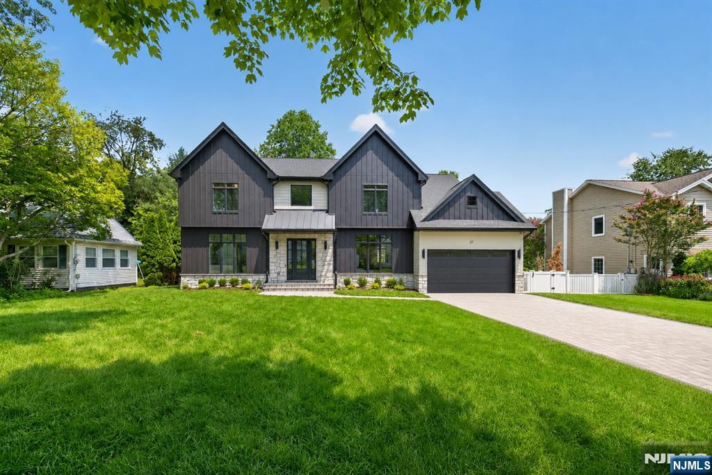 Introducing 27 Crestwood Drive, a newly constructed residence on a new foundation in Glen Rock, New Jersey. Thoughtfully designed for modern living, this expansive home offers 7 bedrooms and 5.5 bathrooms across a generous, open layout. The first floor features 10-foot ceilings that enhance light and volume throughout the main living areas. An open floor plan creates a seamless flow from the family room to the eat-in kitchen and into a large dining room, ideal for everyday living and entertaining. A spacious first-floor en-suite bedroom includes a walk-in closet and a spa-like bathroom, providing flexibility for guests, extended stay arrangements, or a private home office suite.The second floor is anchored by a large primary suite with two walk-in closets and a spa-like bathroom complete with a soaking tub and double vanity. Four additional well-proportioned bedrooms on this level offer ample space for a variety of needs, whether used as sleeping quarters, office space, or hobby rooms. A conveniently located second-floor laundry room adds to the home's functional layout and daily efficiency. The basement comes finished with a large area, full bathroom, and bedroom. With its new construction on a new foundation, high ceilings, open concept design, multiple en-suite options, and dedicated laundry on the bedroom level, 27 Crestwood Drive delivers a balanced combination of comfort, utility, and contemporary style in Glen Rock.