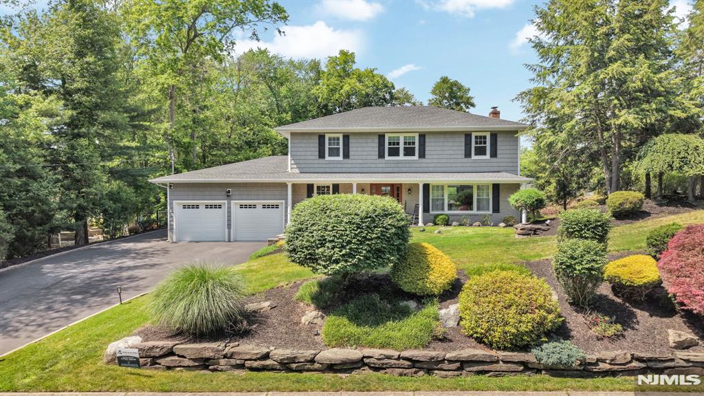 This exceptional colonial blends timeless architecture with sophisticated, recent updates. A welcoming front porch, professionally landscaped grounds & vibrant seasonal blooms create exceptional curb appeal. The foyer features elegant ceramic tile. The reimagined kitchen is the heart of the home, with a striking new island, quartz countertops & sink, built-in beverage fridge, plus new fridge, dishwasher & microwave. Wide-plank luxury vinyl flooring runs throughout the main level, with refined trim in the dining room, walk-in pantry, dedicated laundry room & polished epoxy-floor garage. Upstairs, 4 bedrooms boast rich hardwood floors, abundant natural light & fresh paint. The primary en suite features refined trim detailing, & WIC. One of the four bedrooms offers flexible use as an office with custom built-ins. The finished lower level, with matching luxury vinyl flooring, features a spacious open-concept rec room with dry barâ€”ideal as a media room, gym, or officeâ€”plus a second large room with closet & door for added flexibility or guest use. Outside, the private, fenced backyard is designed for entertaining, with a gas line for grilling and a 10x14 shed. Unwind on the expansive back deck. Approved plans & permits for an in-ground pool are in handâ€”seller willing to transfer to new owner! Wayne offers great schools, Boys & Girls Club, PAL, Wayne Community Center, town pool & town lake. Steps to Pines Lake Elementary & Laurel Woods Arboretum, with shops & dining nearby.