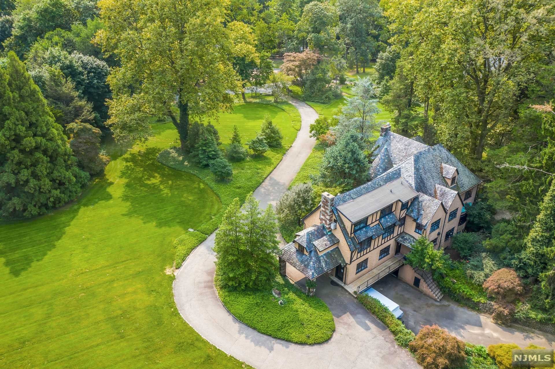 TREMENDOUS OPPORTUNITY!! TOP SADDLE RIVER LOCATION FOR THIS 4.7 AC PROPERTY WHICH OFFERS EXPANSIVE LAWNS, GARDENS,A HORSE BARN, PADDOCK AND RIDING FIELDS! ENJOY FABULOUS SUNSET VIEWS WHILE DINING ON THE COVERED PATIO OR RELAXING BY THE POOL. THE CLASSIC 1927 ENGLISH TUDOR FEATURES BEAUTIFUL STONE & MASONRY WORK AND ENTRY TURRET. THIS 6 BEDROOM HOME ALSO HAS 2 FINISHED ROOMS AND A FULL BATH ON THE 3RD FLOOR FOR POSSIBLE USE AS HOME OFFICE SPACE. QUALITY BUILDING MATERIALS FROM A BYGONE ERA INCLUDE ORIGINAL SOLID WOOD DOORS & HARDWARE, CEDAR LINED CLOSETS, MAHOGANY FLOORING & IRON RAILING WORK IN THE TURRET STAIRWELL. LARGE MASTER SUITE FEATURES FIREPLACE, DRESSING ROOM, BATH AND GREENHOUSE ROOM WITH SAUNA & SPA. MOST BATHROOMS HAVE ORIGINAL VINTAGE TILE. THIS CHERISHED HOME AWAITS NEW OWNERS TO CREATE WONDERFUL MEMORIES. UNIQUE GROUNDS AND SETTING!