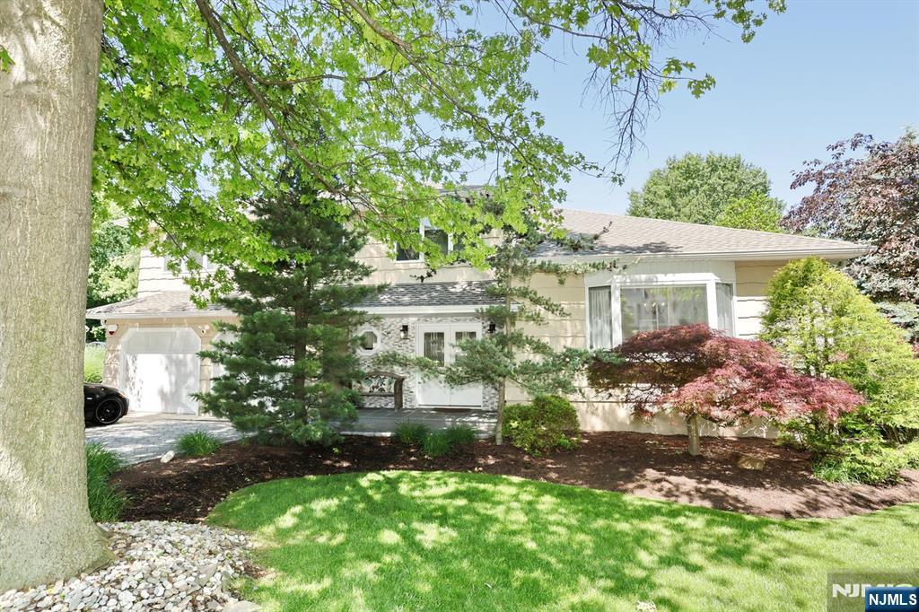 Beautifully maintained Split Level house on the prestigious East Hill of Leonia. Parklike landscaping sets the house apart. A large Entry Foyer greets you as you walk into the ground level. A large Family Room with a gas fireplace, a Bedroom and Full Bathroom await you there. The first floor is made up of a Living Room, Dining Room and Eat in Kitchen. There is a sliding glass door in the kitchen leading to a large deck for your outdoor pleasure. On the second floor, you will find a large Main Bedroom with Full Bath, three more Bedrooms and another Full Bath. There is a door in one bedroom leading to a Finished Attic. There is a two car attached garage with parking for three cars in the driveway. The house has an alarm system, sprinkler system with WiFi controller, 3 year old roof, gutters and skylights, 11 year old HVAC, new electrical panel and 3 Ring spotlight cameras.