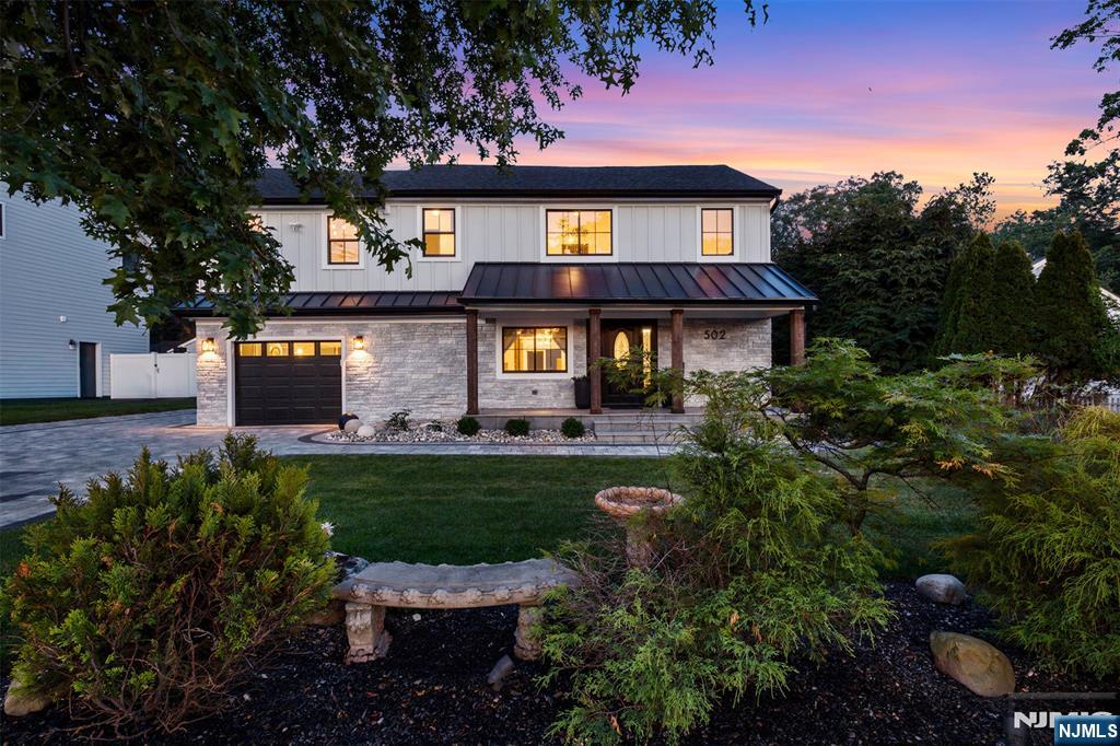 Welcome to 502 Closter Dock Road, where timeless elegance meets modern luxury. Completely renovated from top to bottom within the last two years, this exceptional move-in-ready residence showcases quality craftsmanship and high-end finishes throughout. Offering 3 spacious bedrooms and 4 beautifully renovated full bathrooms, this home is designed for comfort and effortless living. The sun-filled interior features premium hardwood flooring, elegant finishes, and a thoughtfully designed floor plan ideal for everyday living and entertaining. The inviting living room, anchored by a fireplace, creates the perfect gathering space, while the stunning eat-in kitchen serves as the heart of the home with designer finishes, radiant heated floors, and ample space for family and guests. The primary suite features separate his-and-hers walk-in closets and a dedicated washer. Exterior improvements include a new roof with partial metal roofing, premium Hardie fiber cement siding and CERTAplank reinforced siding, Andersen windows, new gutters, a custom stone paver driveway and walkways, professional landscaping, exterior lighting, and an underground sprinkler system. Additional features include a 240 volt EV charging system in the garage and a Ring security system with installed sensors and keypad. Perfectly blending modern convenience with timeless style, this turnkey home offers an exceptional opportunity in one of Closter's most desirable locations. Simply unpack and enjoy.