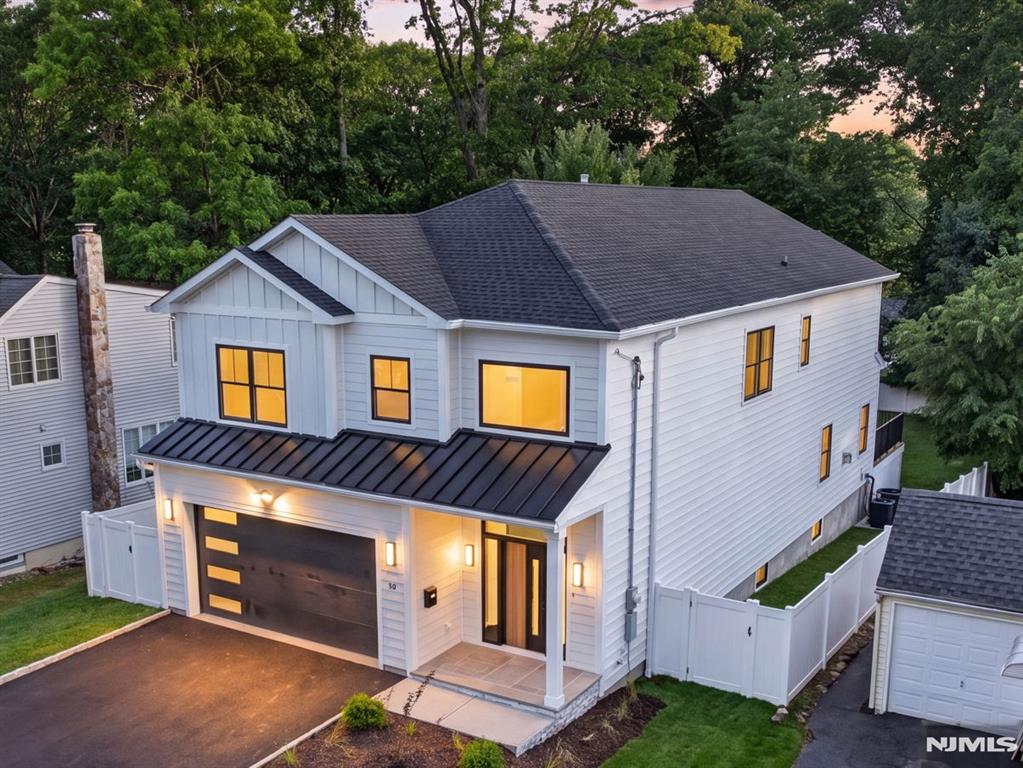 Experience modern elegance and thoughtful design in this stunning custom new construction home featuring 6 ensuite bedrooms, white oak floors, and a grand double-height foyer. The first floor offers an oversized great room with a stone veneer gas fireplace and access to a maintenance-free Trex deck overlooking the fenced backyard; a chef's eat-in kitchen with quartz countertops, large island and stainless steel appliances; a formal dining area; a 1st-floor bedroom with ensuite bathroom; powder room; and attached 2-car garage. Upstairs, the luxurious primary suite boasts dual walk-in closets and a spa-like bathroom with soaking tub and large shower. Three additional bedrooms each have private ensuite bathrooms. The lower level includes a spacious recreation room with additional space for a media room or gym; a sixth ensuite bedroom; and ample storage. Premium finishes include dual-zone heating and cooling, gas fireplace with remote, and interior drainage system. Outside, enjoy a covered bluestone porch, smart front door with keyless entry, professional landscaping with a six-zone sprinkler system, and a fenced yard. Located on approximately 0.23 acres in the top-rated Livingston Public School District, with easy access to shopping, dining, Route 10, and just 15 miles to Newark Airport. This home perfectly blends luxury, comfort, and convenience for your ideal lifestyle.
