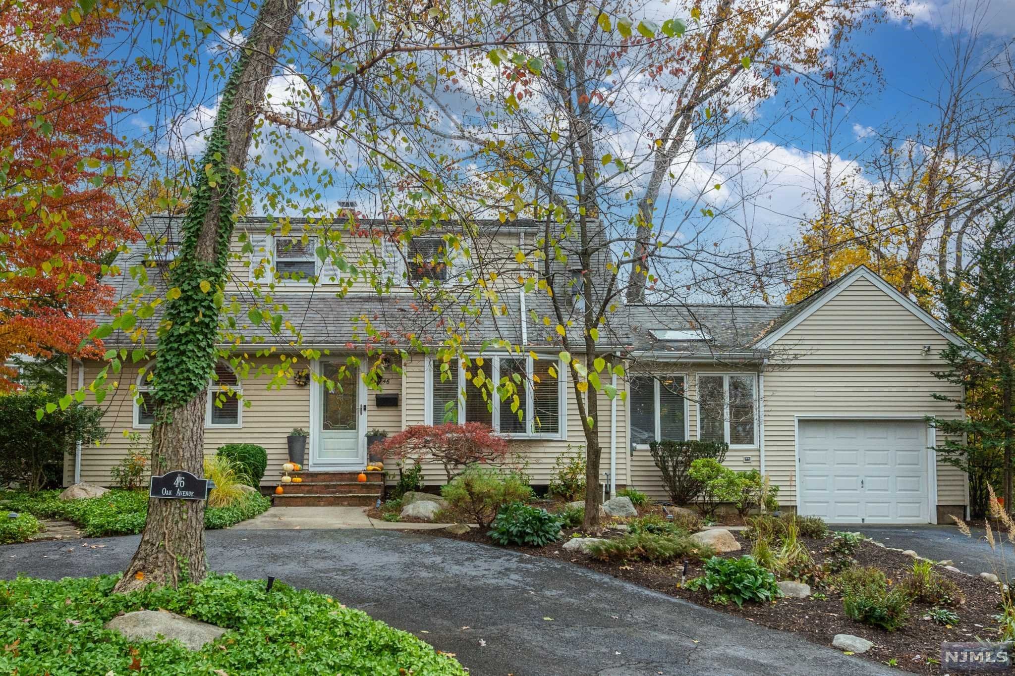 Move right in to your sunlit new home located on a quiet street in sought after Park Ridge. Unwind in your open and airy living room. Host a delicious brunch in your sunny Dining Room featuring a Skylight. Relax on your private deck and savor the tranquil Koi Pond. Entertain your guests in the warm and inviting great room. Enjoy outdoor recreation in the spacious yard. This meticulous home features a circular driveway, in-ground sprinklers, hardwood floors, new exterior doors, Miele & LG appliances, renovated 2nd floor bathroom, full basement & water softener. 2 bed/1 bath on 1st floor, 2 bed/1 bath on 2nd floor. Close to highly rated schools, NYC train & bus, parks, shopping and dining. Desirable Park Ridge has a town pool and lots of activities & events. A true hidden gem.
