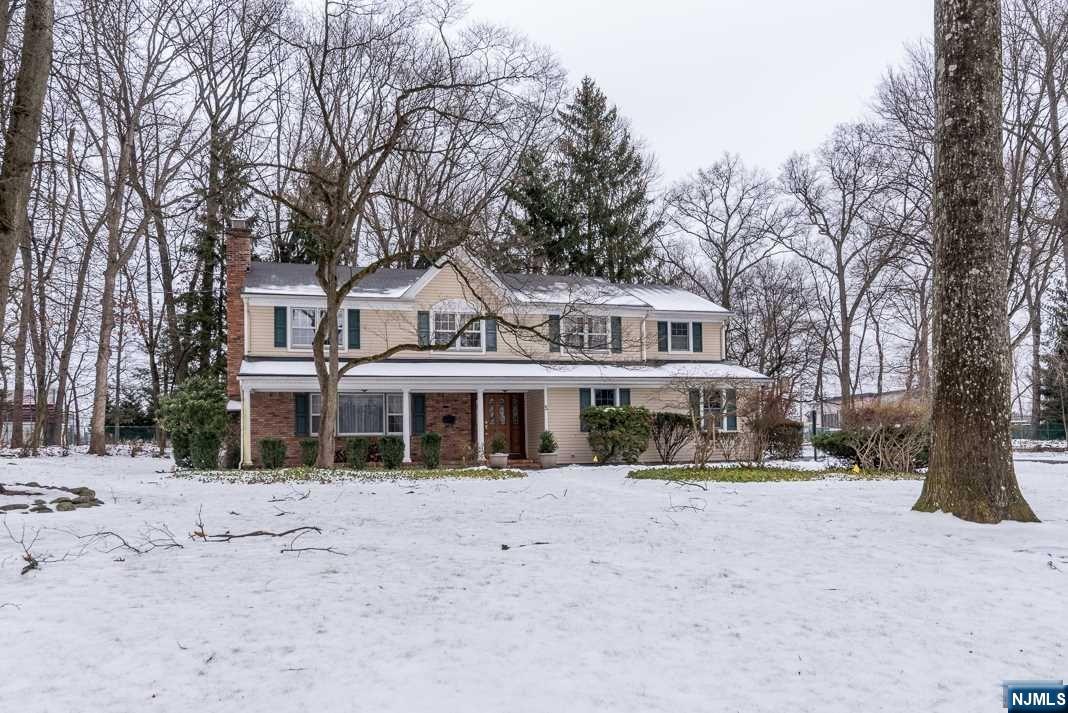 Whether sipping lemonade on the front porch or BBQing on the rear paver patio, you will enjoy the good life in this classy colonial on almost .92 acre. This fantastic home is located in a neighborhood of tree lined streets and well maintained homes as well as being close to all three public schools. It is a truly an entertainer's home where one room flows into another. It boasts a huge great room with vaulted ceiling, many windows and a woodburning fireplace. The library/den, off the kitchen, has built-in bookcases and another woodburning fireplace. It's ideal for intimate gatherings of friends and family. A third fireplace is in the living room. The kitchen has lots of cabinets and granite counters. The primary suite is spacious with two large walk-in closets and a super primary bath with whirlpool tub an large stall shower. Three more bedrooms, a bathroom and laundry room complete the second floor. Two car garage. Expansive front and back yards.