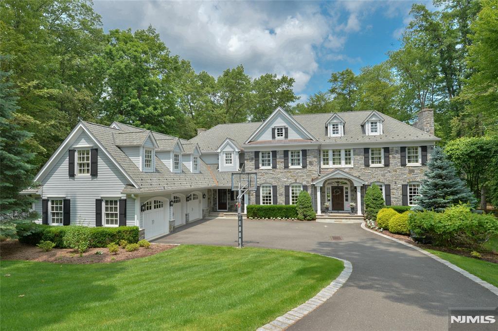 Elegant colonial showcasing intricate and refined woodworking and detailing throughout. Nestled on over 2.5 acres, the property features a free-form Marson pool with waterfalls, full service cabana, veranda, patio, firepit, 3 car garage and expansive, lushly landscaped grounds. A front-to-back marble foyer leads to a picture-perfect loggia overlooking the grounds, situated between the library and kitchen. The primary suite with fireplace and luxury marble bath and 2 walk-in closets offers exceptional views of the property. The media room (5th bedroom) is very large and versatile for guests or extended family. The lower level provides additional living space, perfect for workouts and relaxation. Two offices on the first floor are ideal for today's lifestyle. This very special residence is situated at the end of a prime cul de sac.