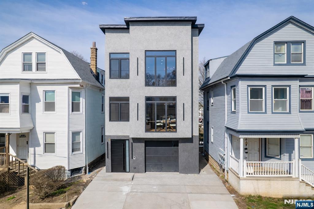 Exceptional new-construction two-family residence situated on an oversized lot in the heart of Irvington. Thoughtfully designed with modern finishes and functional living spaces, this property offers the perfect blend of style, comfort, and value. Features include 9-foot ceilings, hardwood flooring, European-style windows, designer tile finishes, and abundant natural light throughout. The gourmet kitchen is appointed with quartz countertops, stainless steel appliances, and a spacious center island ideal for everyday living and entertaining. The primary suite offers a walk-in closet and a beautifully designed ensuite bath. The finished lower level provides flexible bonus space suitable for a recreation room, media room, fitness area, home office, or additional living space, and includes a half bath, laundry area, an oversized garage and additional parking. Conveniently located near parks, shopping, dining, major highways, and public transportation with easy access to New York City. A rare opportunity to own a newly built income-producing property with exceptional value. Five-year tax abatement benefit applies.