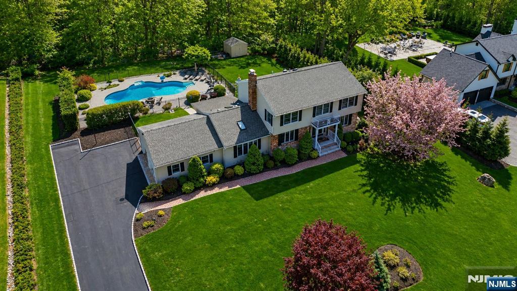 Back on market. Buyer unable to perform. Welcome to 112 Urban Club Rd, a beautifully reimagined Colonial set on nearly an acre of private property. This impressive home offers 4 Bedrooms, 3.1 Baths, a seamless blend of scale, design & function. Grand entry foyer opens to sun-filled living spaces featuring Andersen windows t/o. Show-stopping custom Kitchen is designed to impress, showcasing matte black cafe appliances, dual sinks w/prep station, refrigerated drawers, Caesarstone counters w/full backsplash, walnut shelving & large center island w/breakfast seating. The adjacent formal Dining Rm makes a bold statement w/herringbone wall detail, custom built-ins & designer finishes. A dramatic Great Rm w/soaring ceiling, exposed beams, shiplap accents & a sleek stucco wood-burning fireplace anchors the home. A 4-season Sunroom ideal for office or relaxation offer flexibility. The main level also includes a Mudrm w/built-in, Powder Rm & access to a 2-car garage w/epoxy flrs. Upstairs features wide plank oak flrs, a Primary Suite w/ WIC & en-suite bath, 3 add'l Bedrms & a recently updated main bath w/double vanity. The finished basement w/full Bath adds bonus 1100 sq. ft of living space, while the updated laundry rm has been thoughtfully elevated to include a large folding area & custom shelving. The backyard is a private oasis, an oversized pool, separately gated for added safety, plus multiple entertaining & lounge areas.