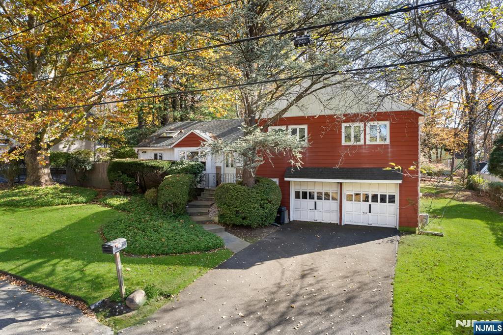 Welcome home to this beautifully maintained 3-bedroom, 2.5-bath split-level residence, nestled in a peaceful, park-like setting with lush landscaping and a meticulously manicured yard. Located on a quiet, tree-lined dead-end street, this charming home combines comfort, thoughtful updates, and natural beauty. Inside, you'll find a freshly painted interior, a spacious sun-drenched living room, and hardwood floors beneath the carpeting. The modern kitchen is highlighted by a skylight that fills the space with natural light, making it perfect for both everyday living and entertaining. The home offers nice-sized bedrooms, including a primary suite with its own private master bath for added comfort and convenience. Additional features include a cozy family room that seamlessly flows from the dining area, a large basement with great potential and ample storage, and recent upgrades such as a brand-new roof and a newer furnace and HVAC system. A two-car garage provides added convenience, and the home is ideally located near Demarest Farmsâ€”offering a quaint country experience with a market, nursery, and seasonal U-pick produce. You'll also enjoy proximity to top-rated schools, houses of worship, NYC transportation, a nearby community pool, and a fireplace and chimney being sold as-is with no known issues. This home is truly a must-seeâ€”schedule your visit today and experience its timeless charm! z