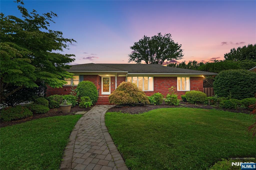 Welcome to this meticulously maintained 3 bedroom, 2.5 bath expanded ranch offering over 2,171 square feet of versatile living space on an oversized 14,431 square foot lot in desirable Elmwood Park. Step inside to find gleaming hardwood floors and an expansive open concept living and dining room filled with natural light from oversized picture windows. The spacious eat in kitchen features granite countertops, abundant cabinetry, double wall ovens, and generous prep space perfect for hosting family and friends. Just beyond the kitchen, the inviting family room showcases exposed wood beams, a beautiful wood burning fireplace, and direct access to the three season room overlooking the backyard retreat. The finished walkout lower level expands your living space with a second fireplace, recreation area, bar, home office, full bath, abundant storage, and flexible space for entertaining, guests, or extended living. Outside, enjoy your own private oasis featuring a fenced in ground pool, paver patio, mature landscaping, and an oversized driveway accommodating more than ten vehicles. Additional highlights include a two car garage with attic storage, 200 amp electrical service, and durable all brick construction. This inviting home offers generous living space, quality craftsmanship, and endless opportunities to make it your own.