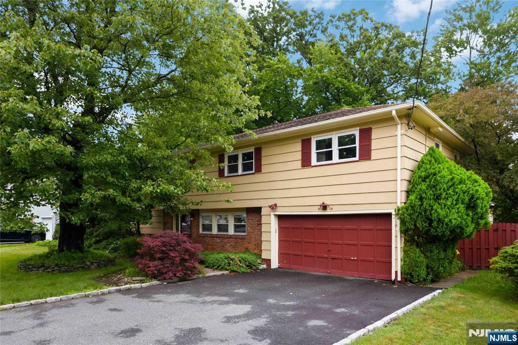 Spacious 4-bedroom, 2.5-bath split-level home with an indoor pool and sauna! Great neighborhood with sidewalked streets, 2-car garage with a den/home office, and an unfinished basement with a workbench. There is a family room with a bar area and laundry. In the pool area, there is a half bath with a toilet/shower and sauna. The primary bedroom has additional closet space, a full bathroom with a shower, and a separate tub. The backyard features a deck off the kitchen and a private patio, creating a backyard oasis. Other features include a wood-burning fireplace in the living room, in-ground sprinklers, an updated water heater, and forced-air heat/AC. Bring your contractor and a vision to create the home of your dreams! Schedule your private showing today before it's too late!