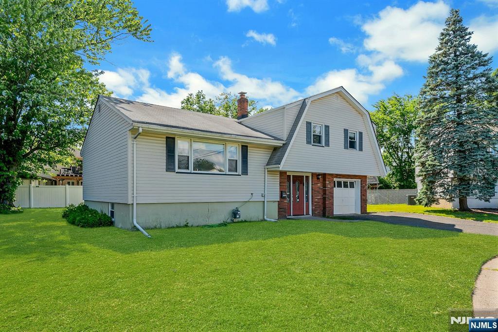 Situated on a peaceful cul-de-sac, this terrific sun-filled Sugar Maple split offers 4 bedrooms and a prime location near Fair Lawn HS & NYC transit and close to houses of worship. Enter the airy tiled entry foyer that leads to a comfortable family room with nearby half bath & laundry and convenient access to both the attached garage and the yard. Up a half-flight you are welcomed to a large sunlit living room with recessed lighting that flows seamlessly into the formal dining room, both featuring hardwood floors. The updated kitchen offers practical functionality with a peninsula and pass-through to the dining room as well as a sizable pantry. The bedroom level features hardwood flooring and 3 spacious and bright bedrooms, including a primary with renovated ensuite bathroom, plus a lovely modern main hall bath. The finished basement provides additional living space with a 4th bedroom, office, large storage room and rec room. With an expansive lot of over 8000sf, this great home assures many pleasure-filled days enjoying the outdoors!